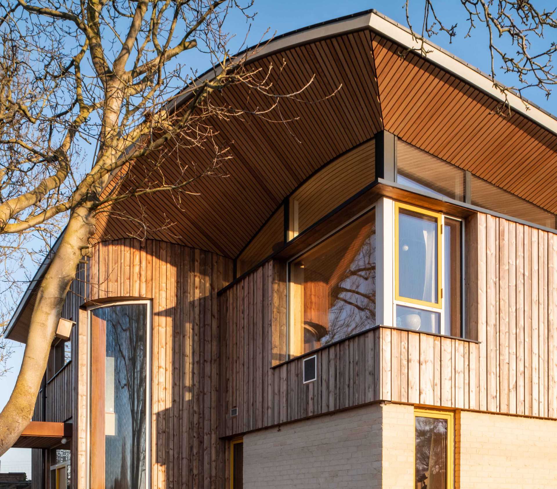 A modern cabin with overhanging wood-lined eaves.