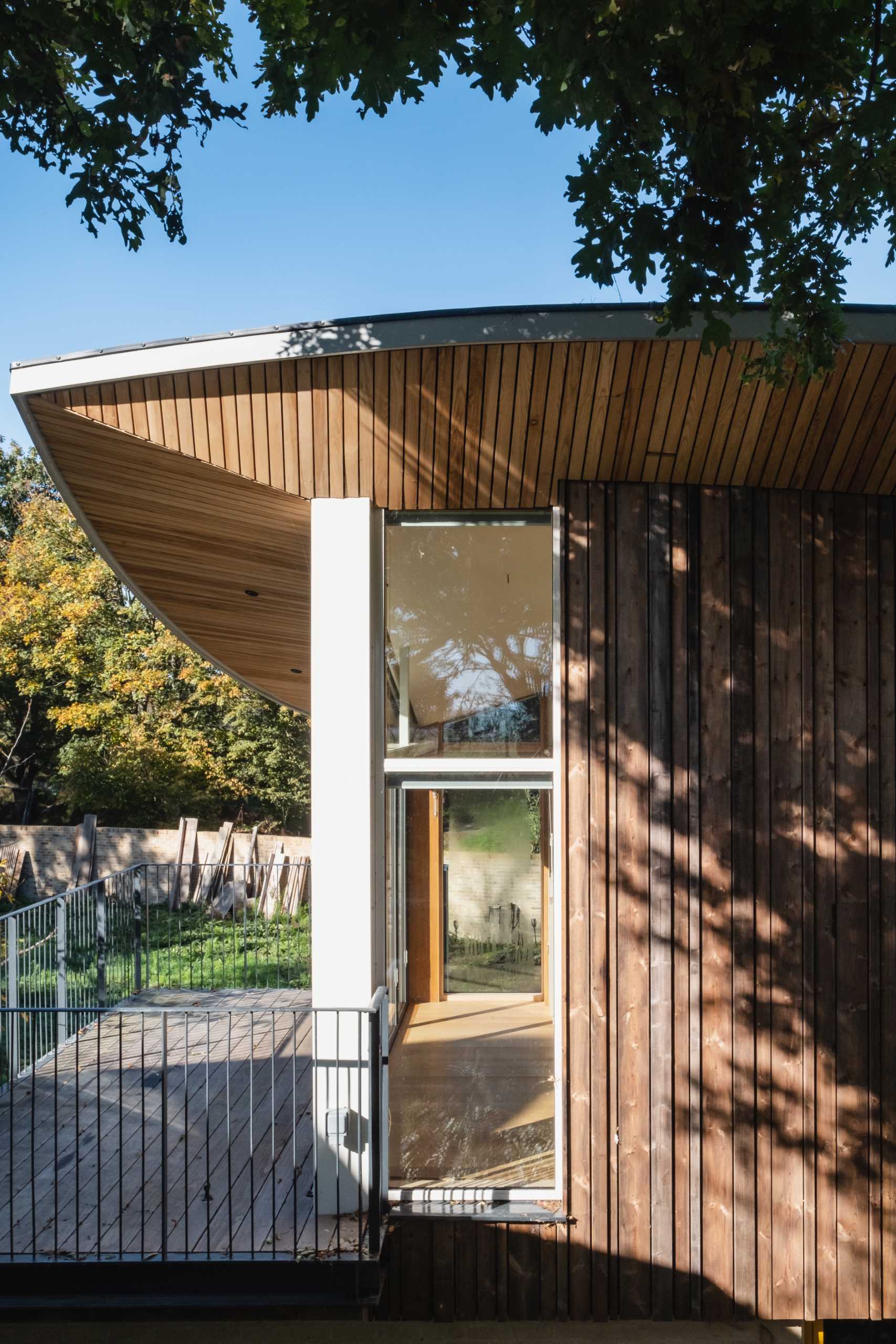 A modern cabin with overhanging wood-lined eaves.