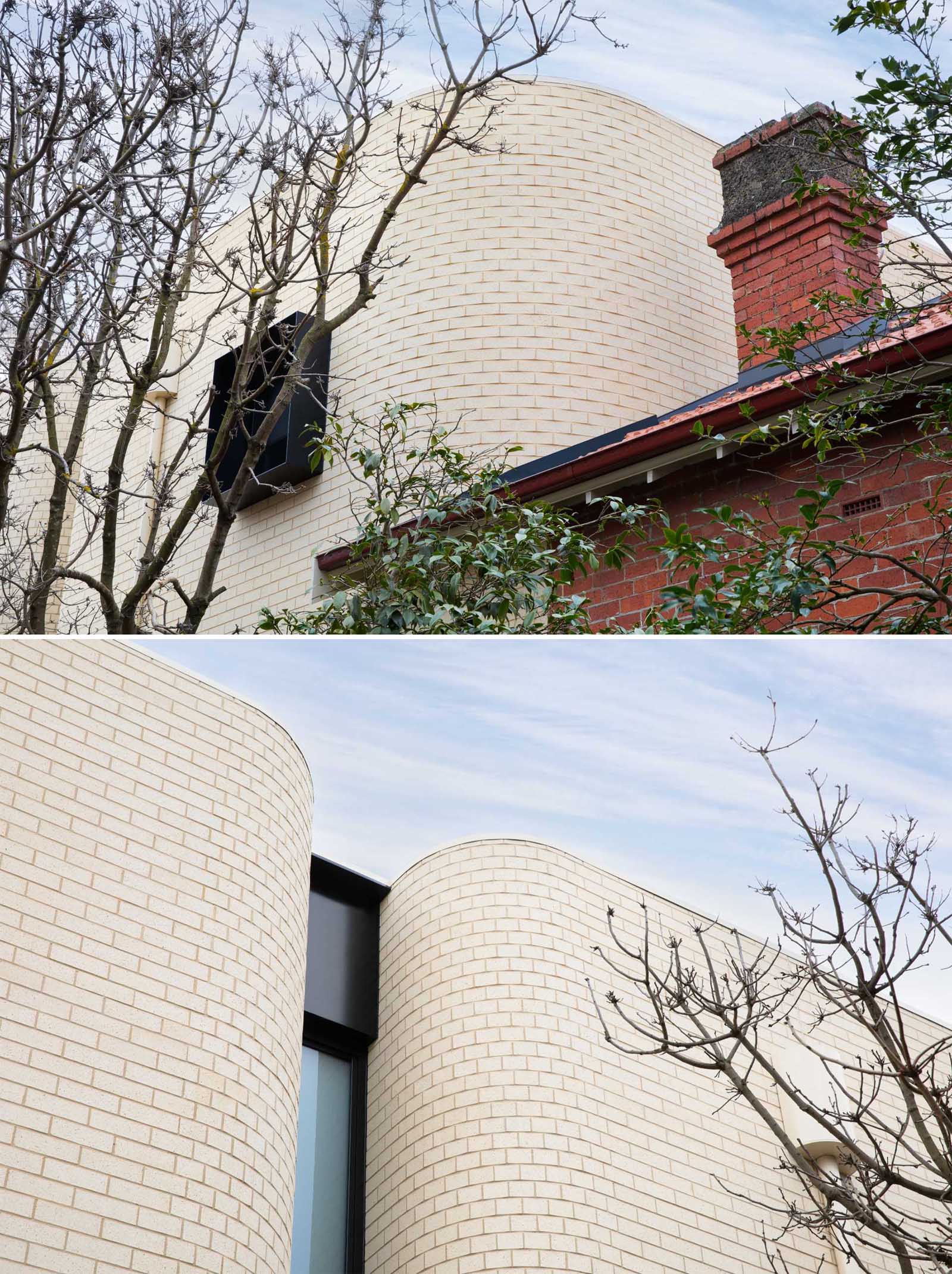 A new light brick rear addition connects to the original red brick home.