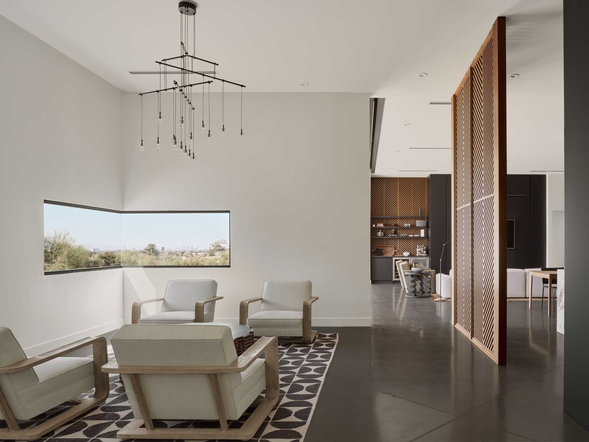 A modern bar and lounge area with a corner window that frames the landscape.