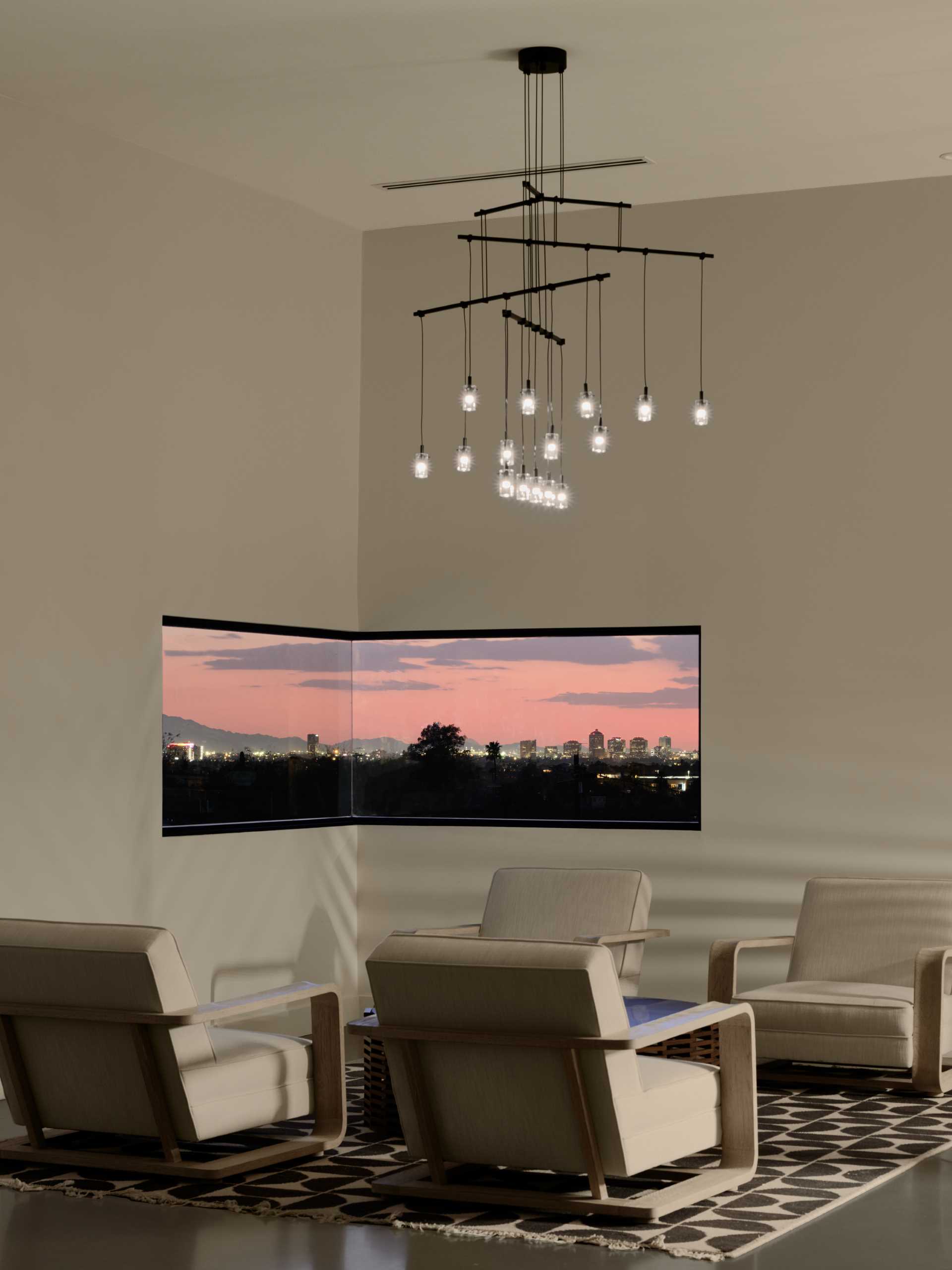 A modern bar and lounge area with a corner window that frames the landscape.