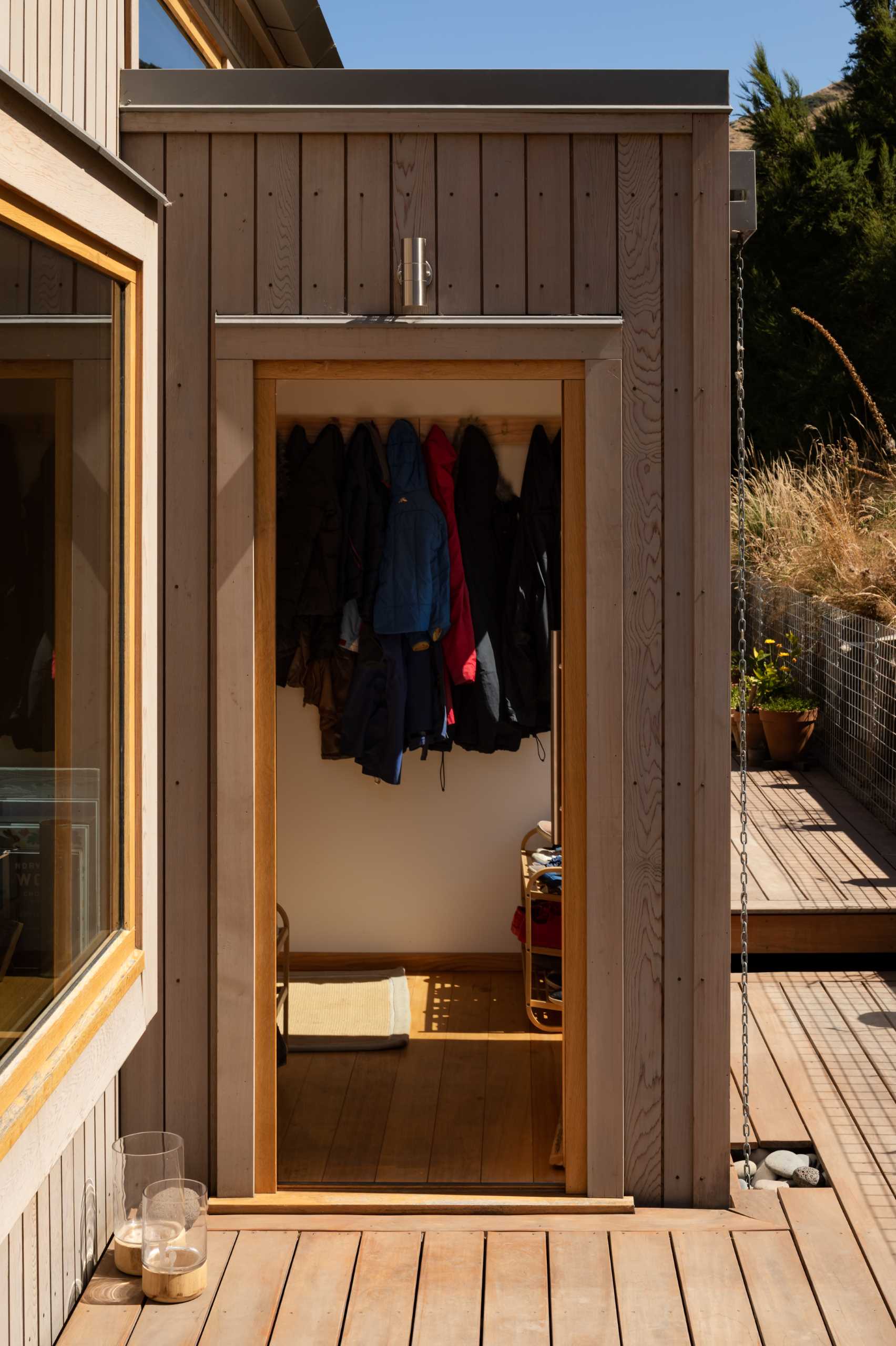 The wood exterior of this modern home continues through to the interior, where it was given an oil finish to retain its rich reddy-yellow hues.