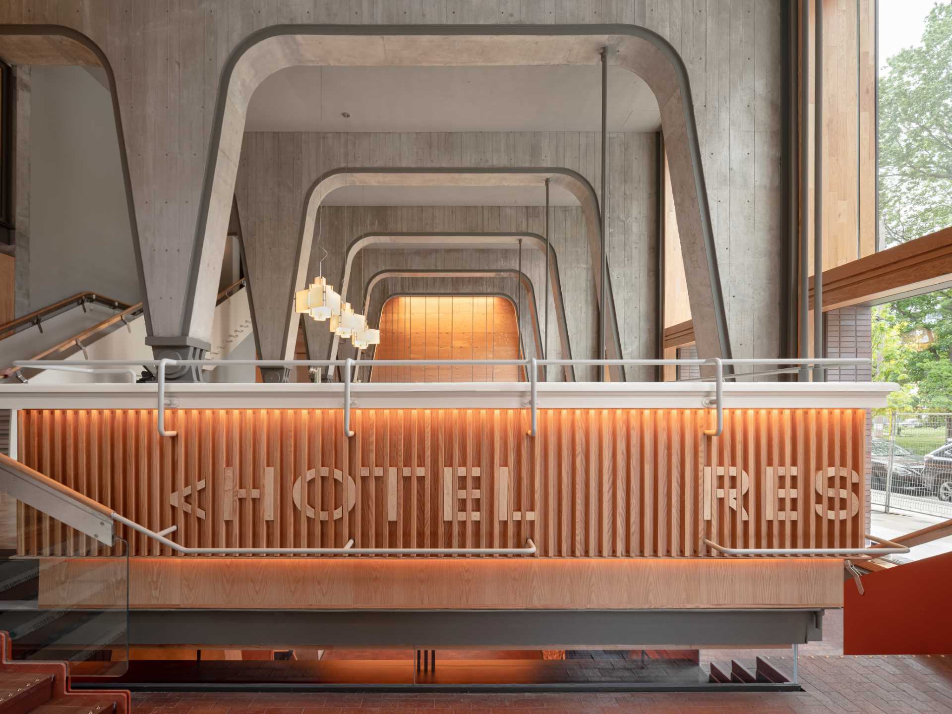 The Ace Hotel in Toronto has a loft lobby featuring concrete and wood elements.