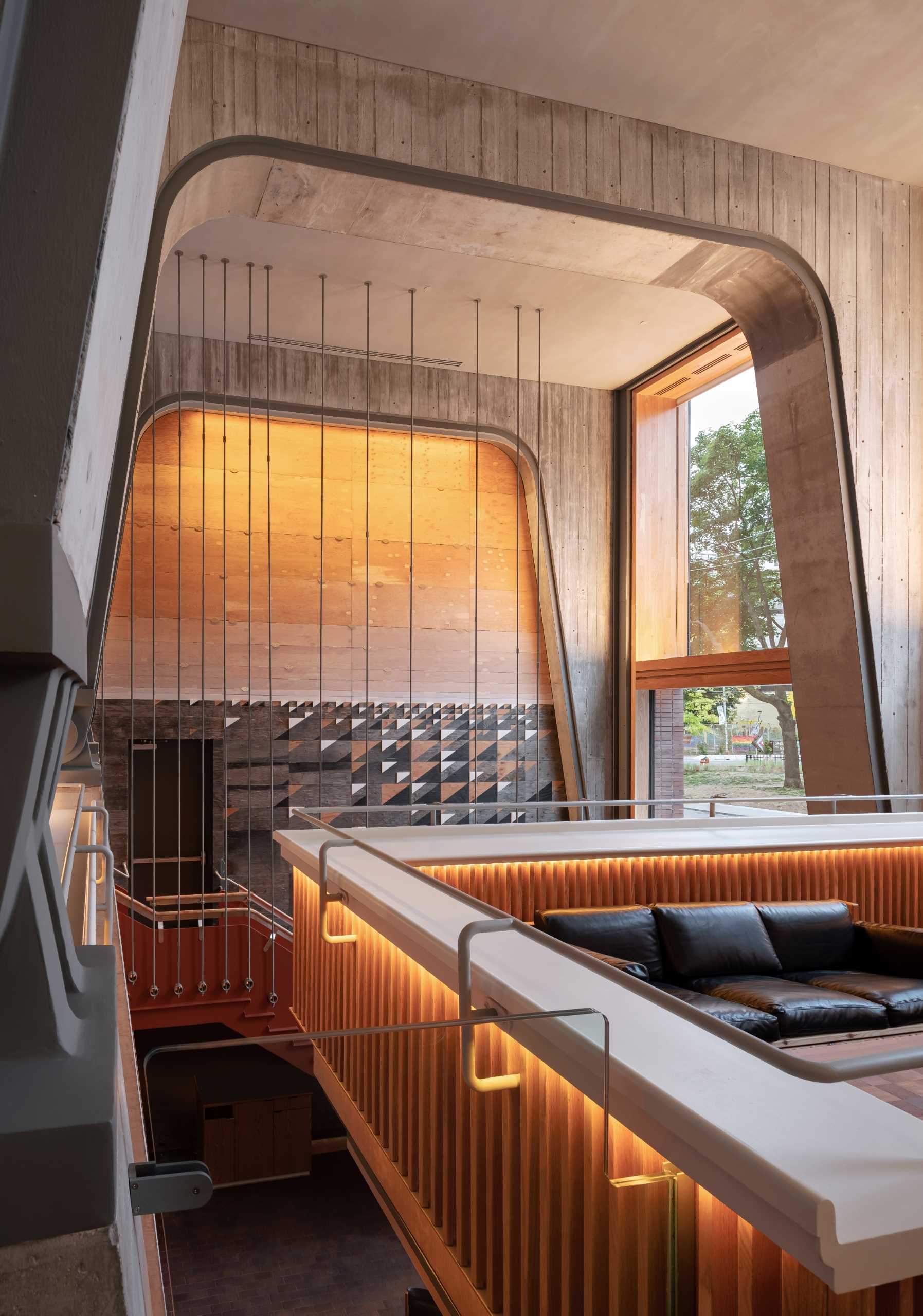 The Ace Hotel in Toronto has a loft lobby featuring concrete and wood elements.