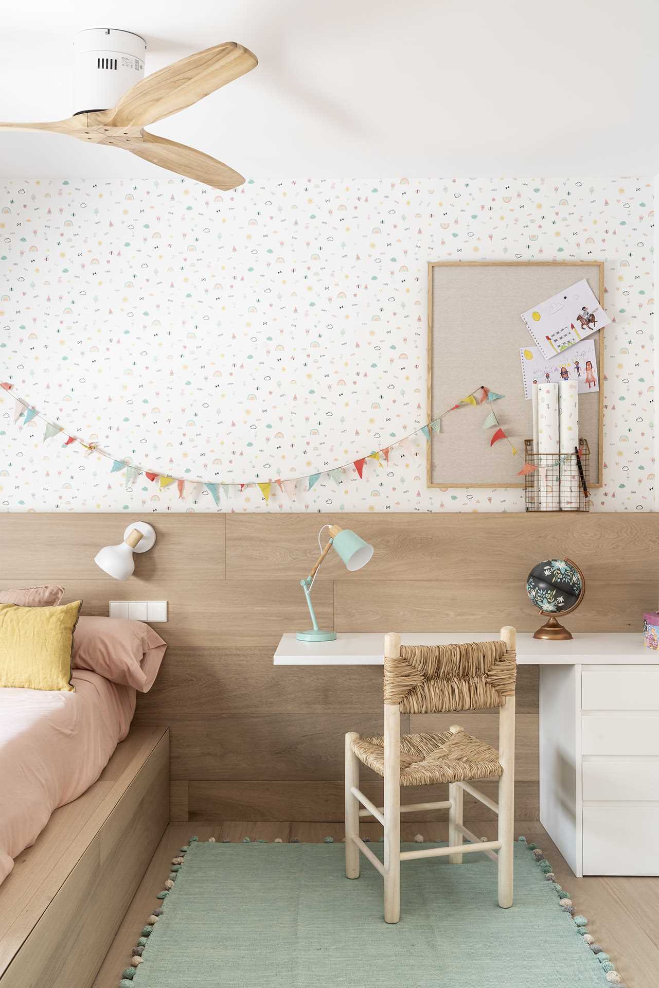 In this kids' bedroom, wallpaper and decorative accents add a fun pop of color.