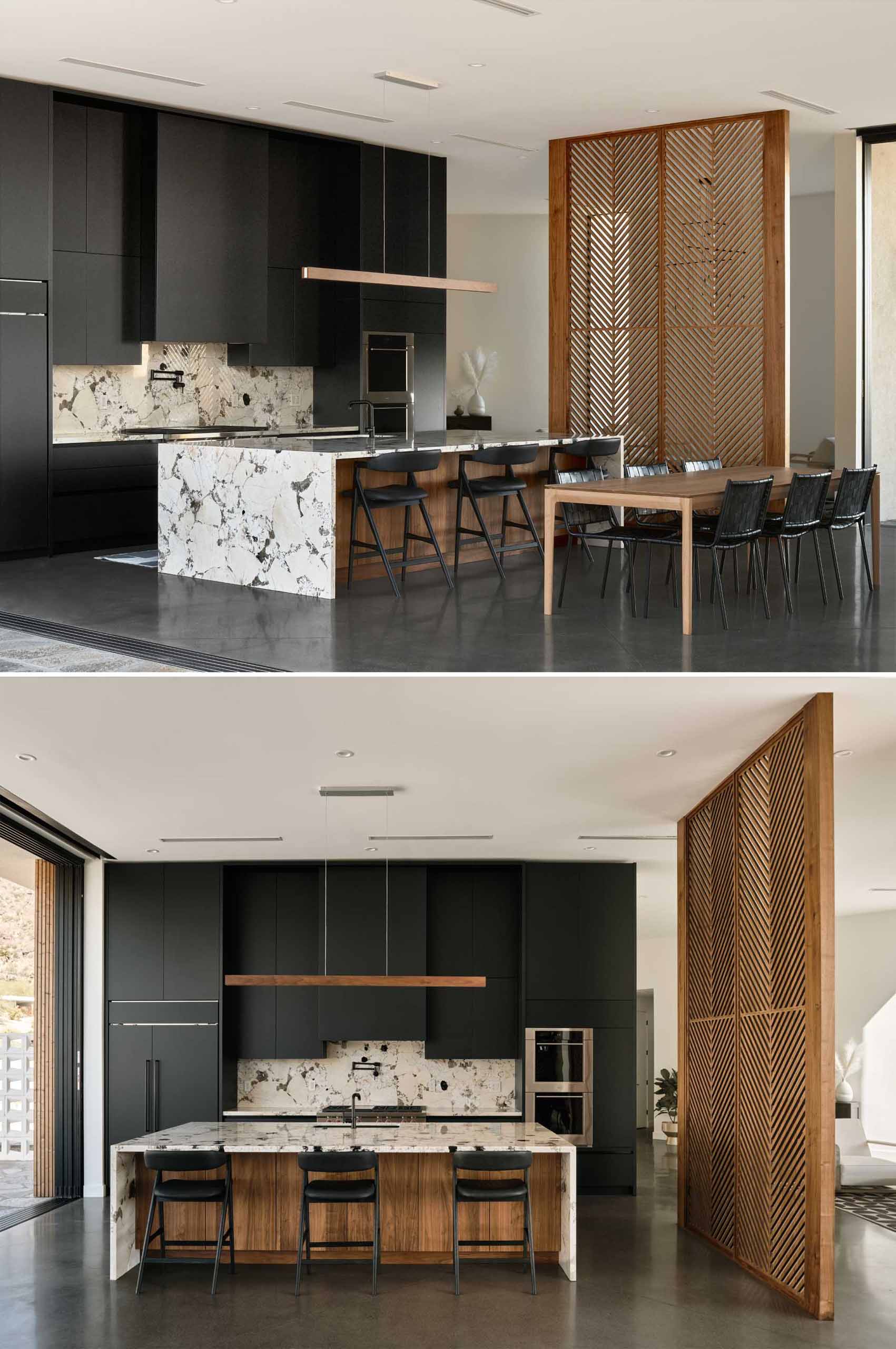 A modern kitchen with a wood partition screen with wood panels inspired by palm fronds.