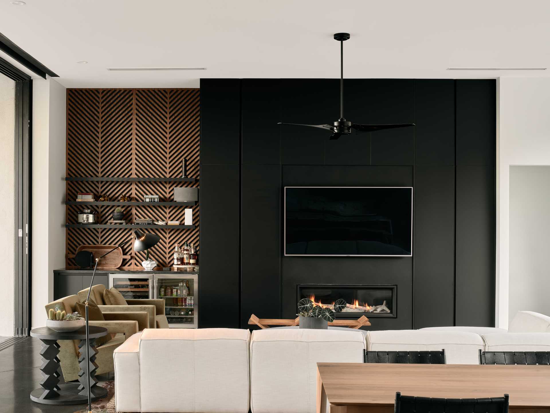 This modern living room with a black accent wall.