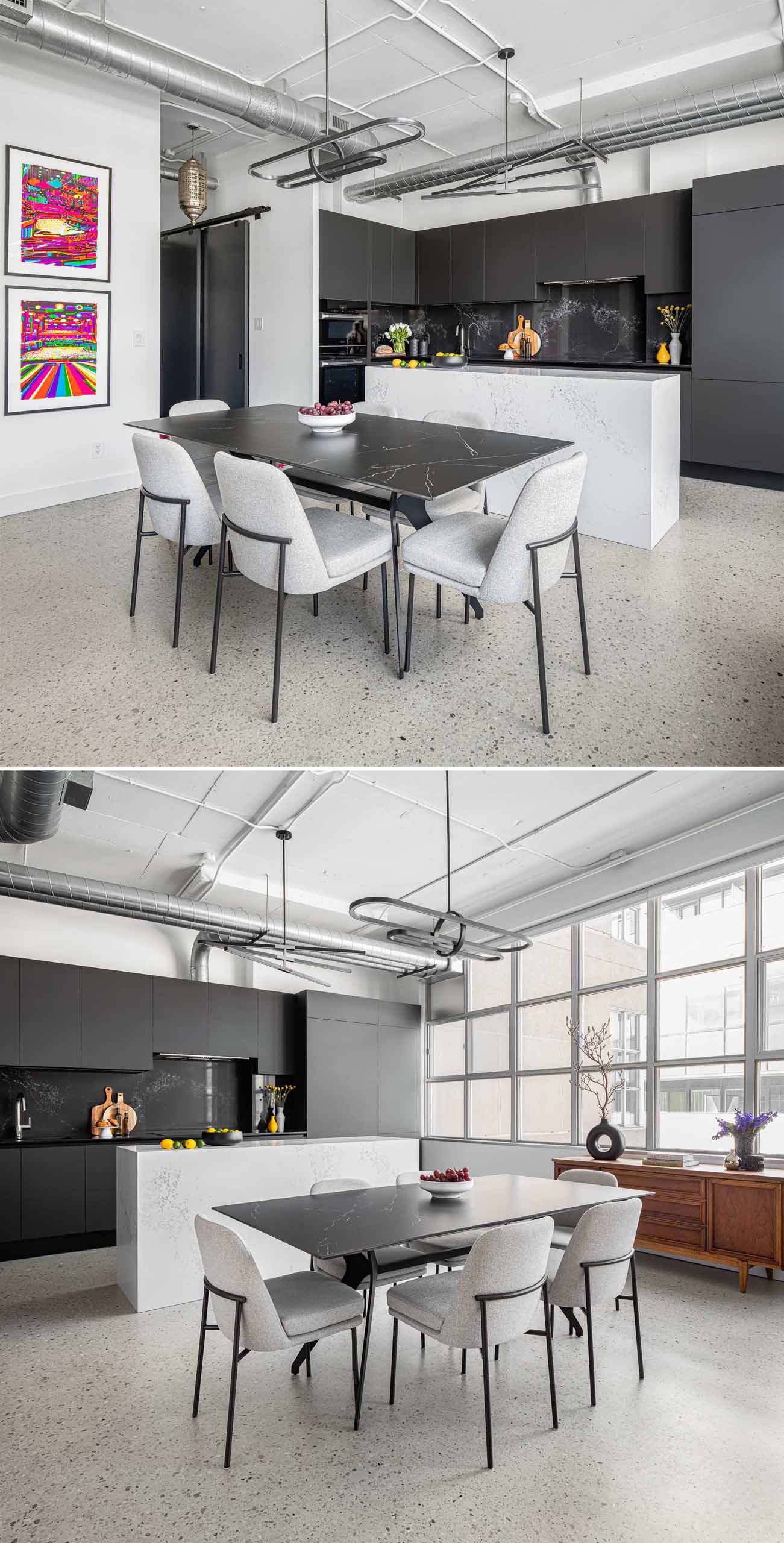 This open-plan dining area in a loft apartment has been furnished with a black ceramic dining table with dramatic veins which is surrounded by more subtle grey upholstered chairs. 