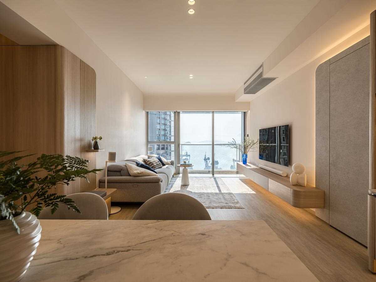 A modern open plan dining area and living room with hidden LED lighting.