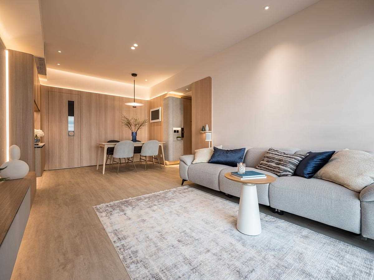 A modern open plan dining area and living room with hidden LED lighting.