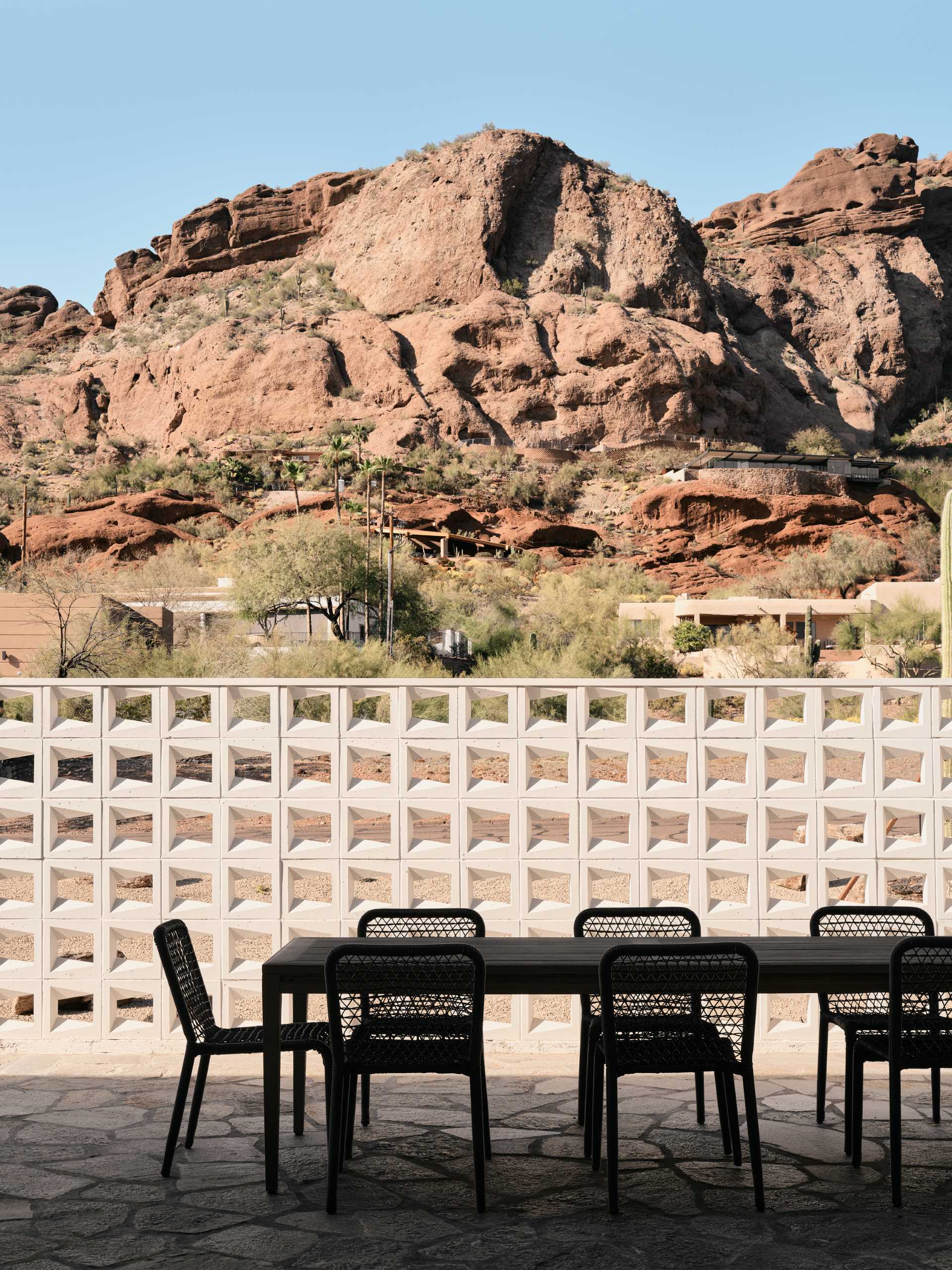 A desert home with patio that has privacy provided by mid-century modern inspired breezeblocks.