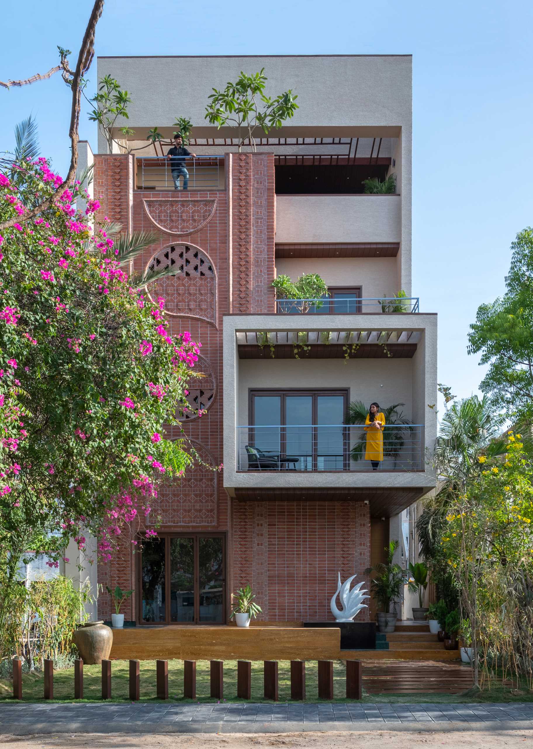 A modern home facade with a variety of brick patterns and unique designs.