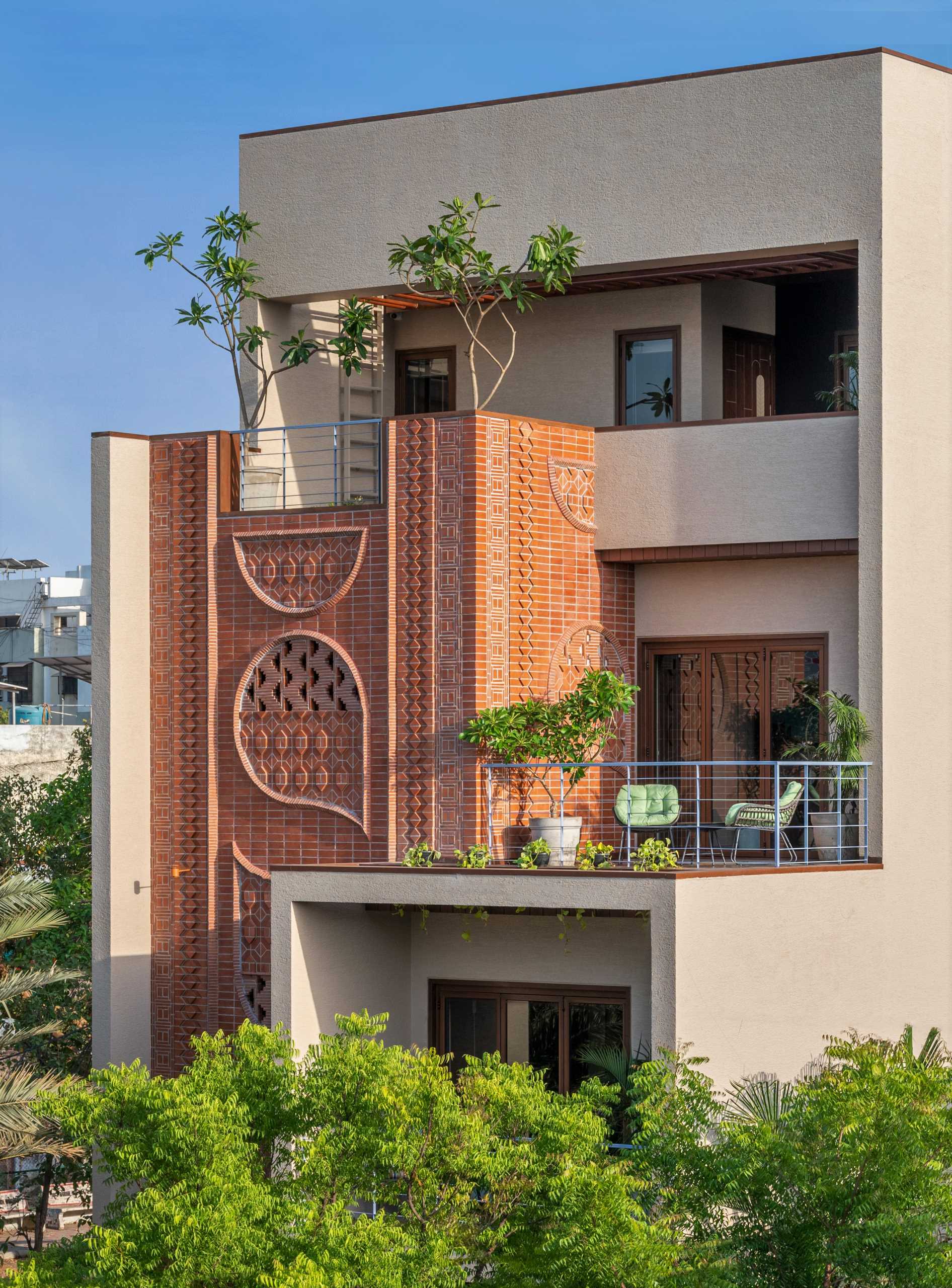 A modern home facade with a variety of brick patterns and unique designs.