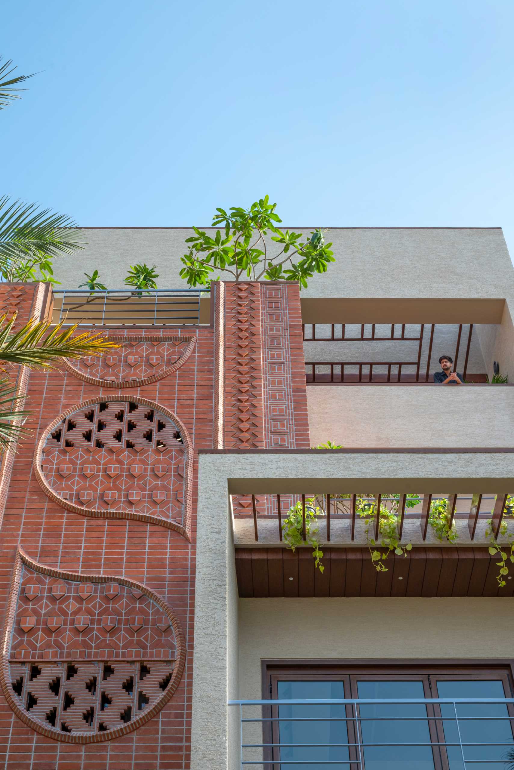 A modern home facade with a variety of brick patterns and unique designs.