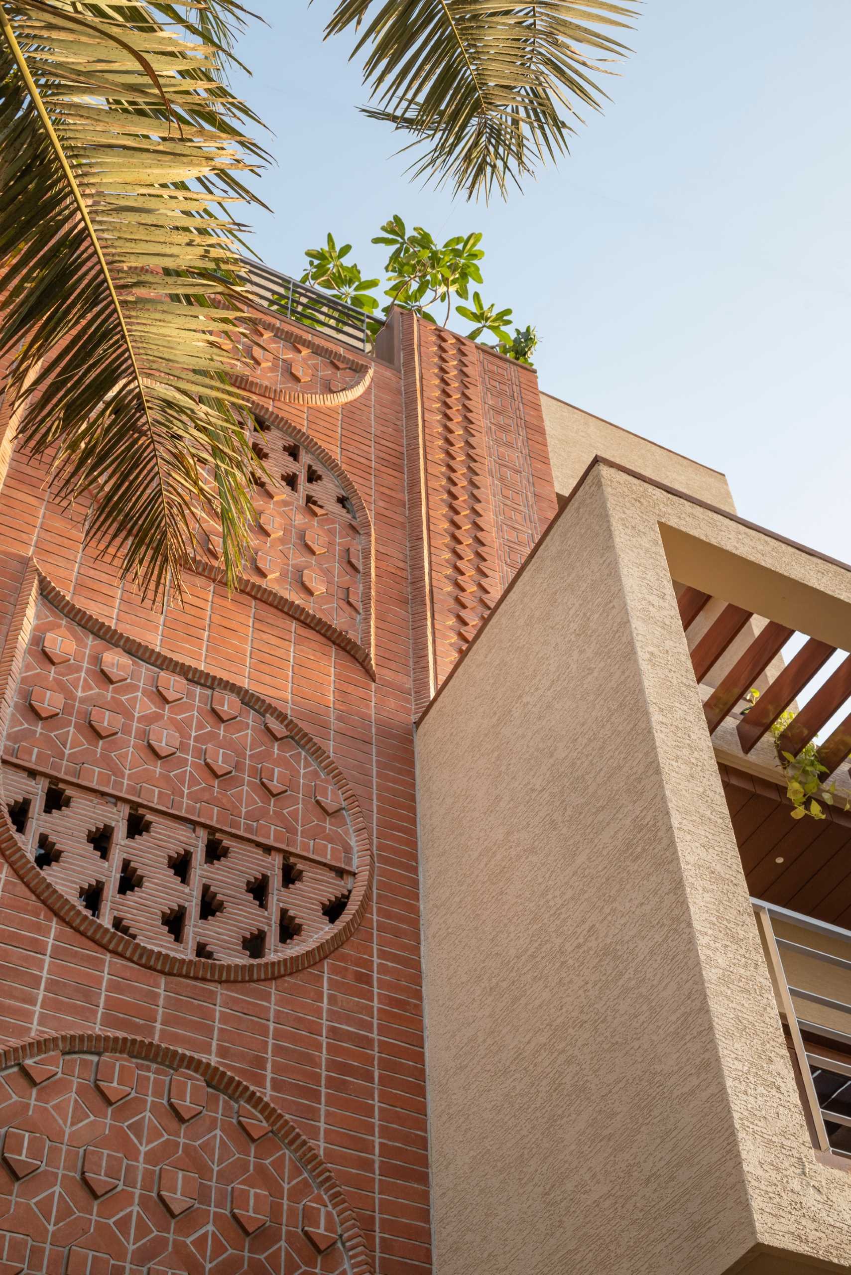 A modern home facade with a variety of brick patterns and unique designs.