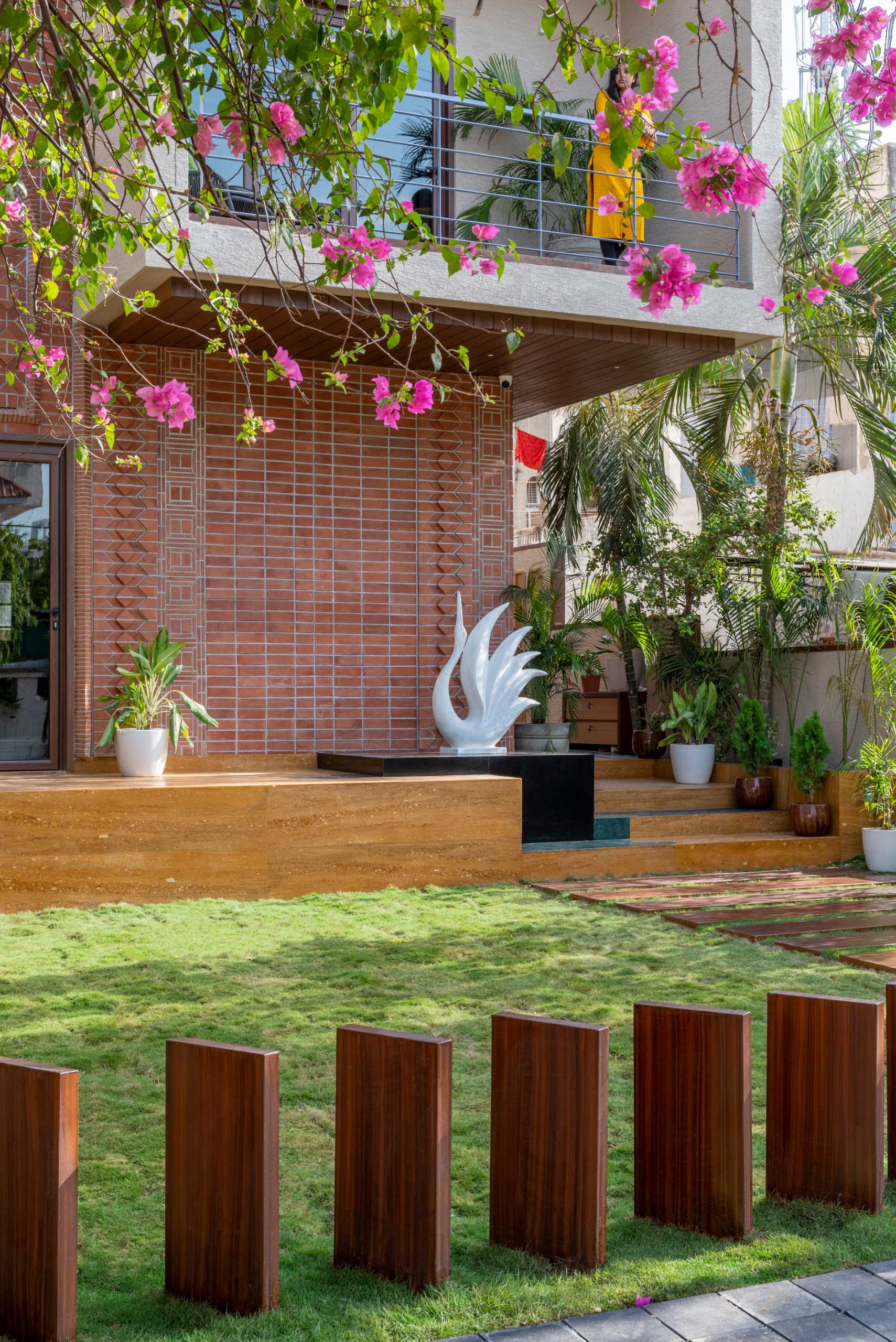 A modern home facade with a variety of brick patterns and unique designs.