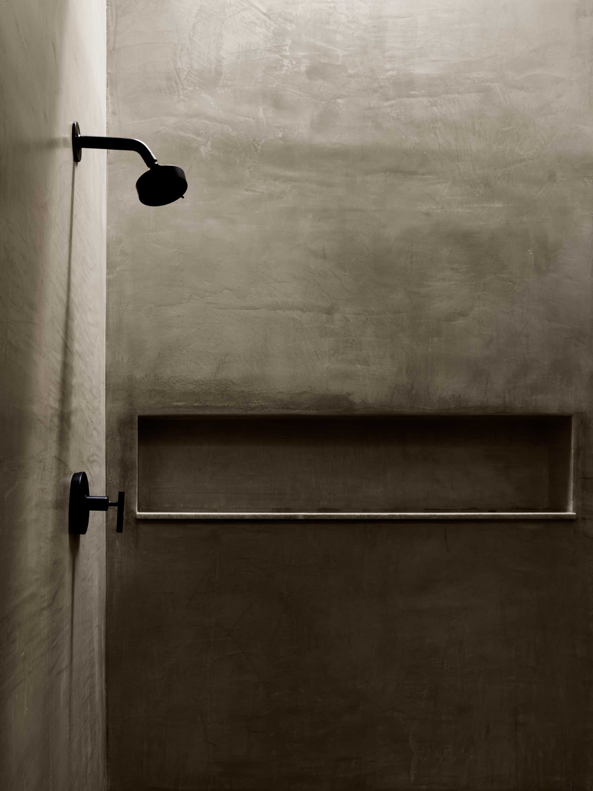 A modern shower with a shelving niche.