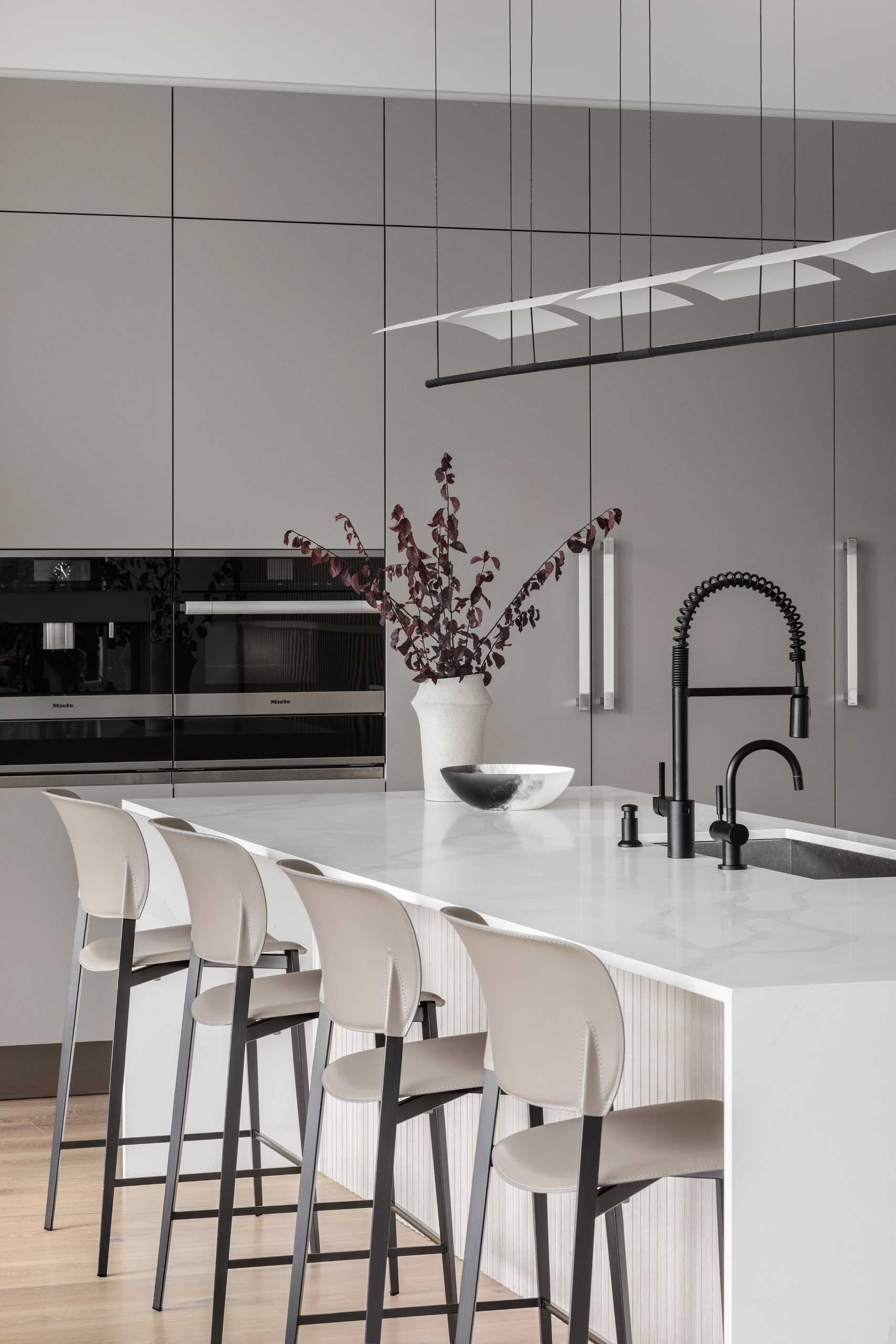 A modern kitchen includes minimalist cabinets and a large island.