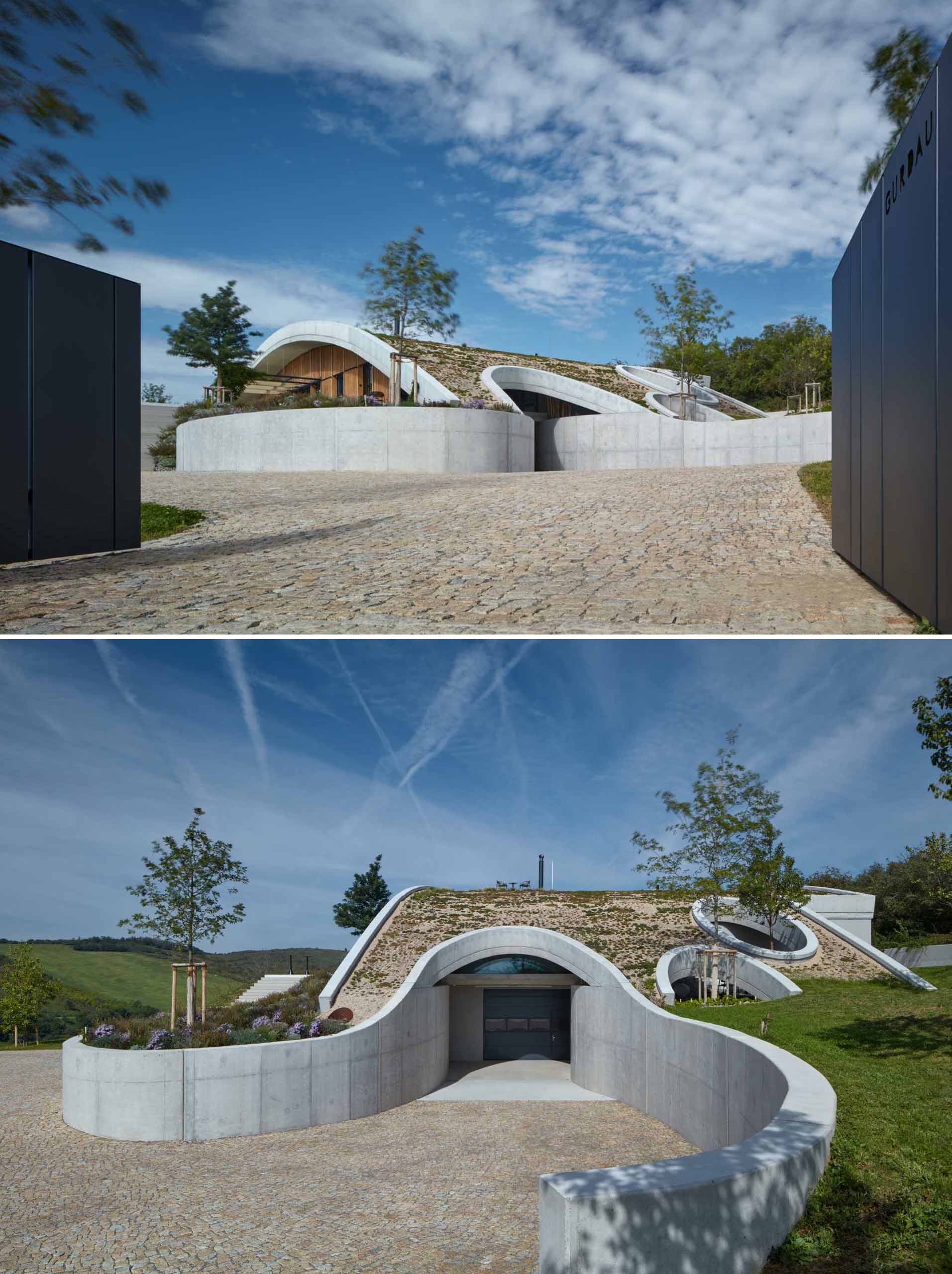 A modern winery that's built with a curved green roof to allow it to blend in with the landscape.