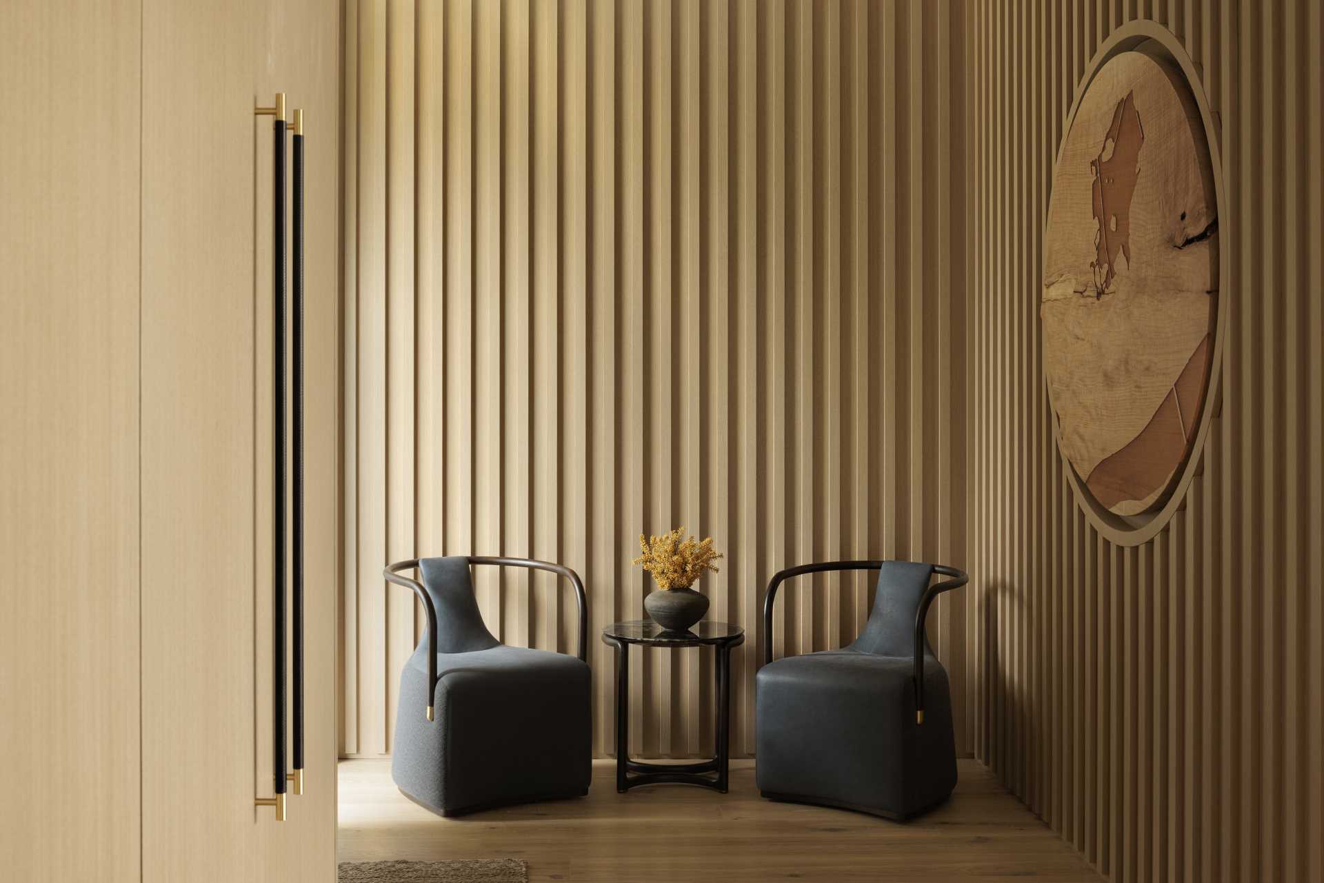 A modern entryway with slatted wood panel walls.