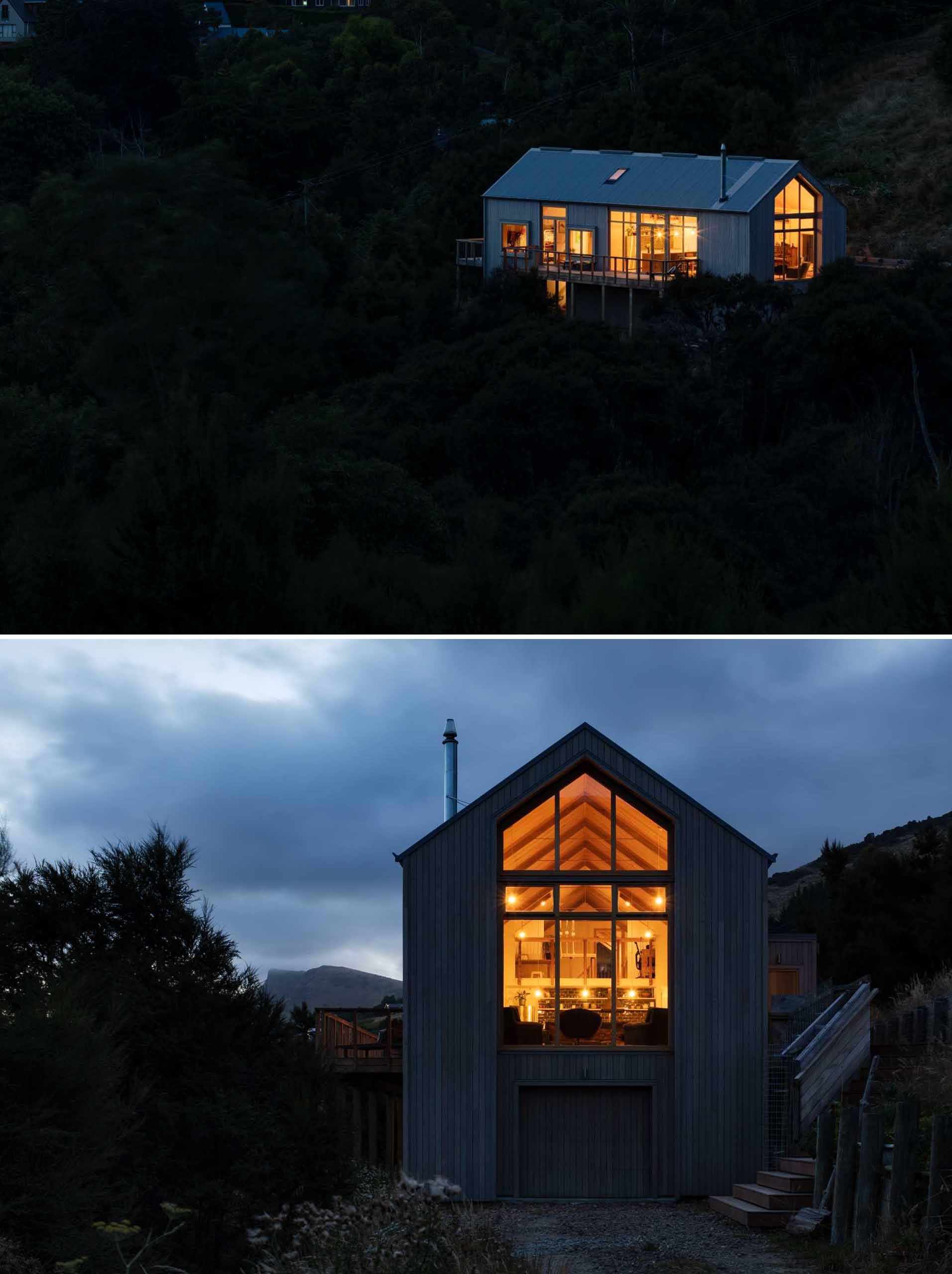 At night, this modern home lights up like a lantern on the hillside.
