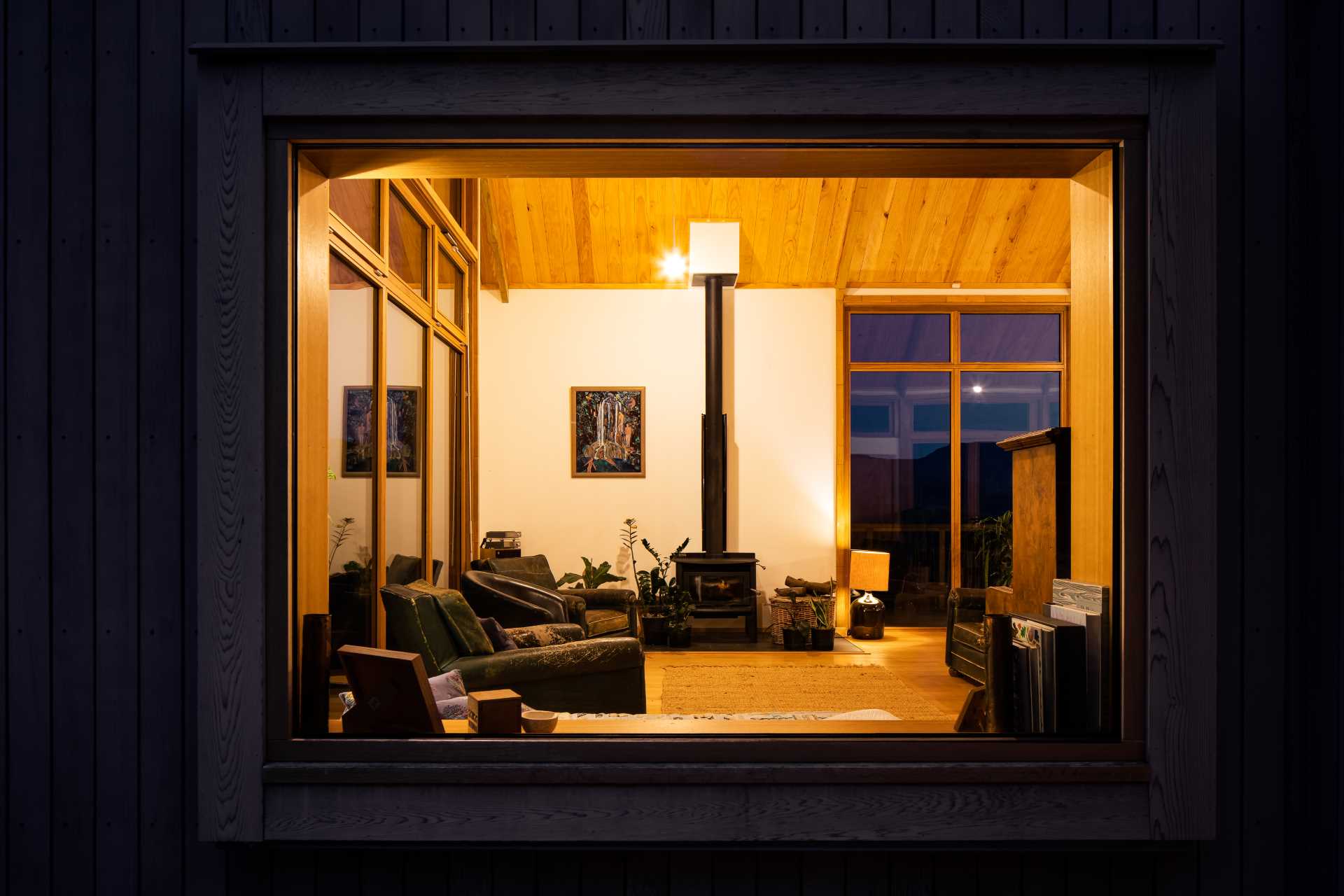 The view of the living room at night showing the fireplace.