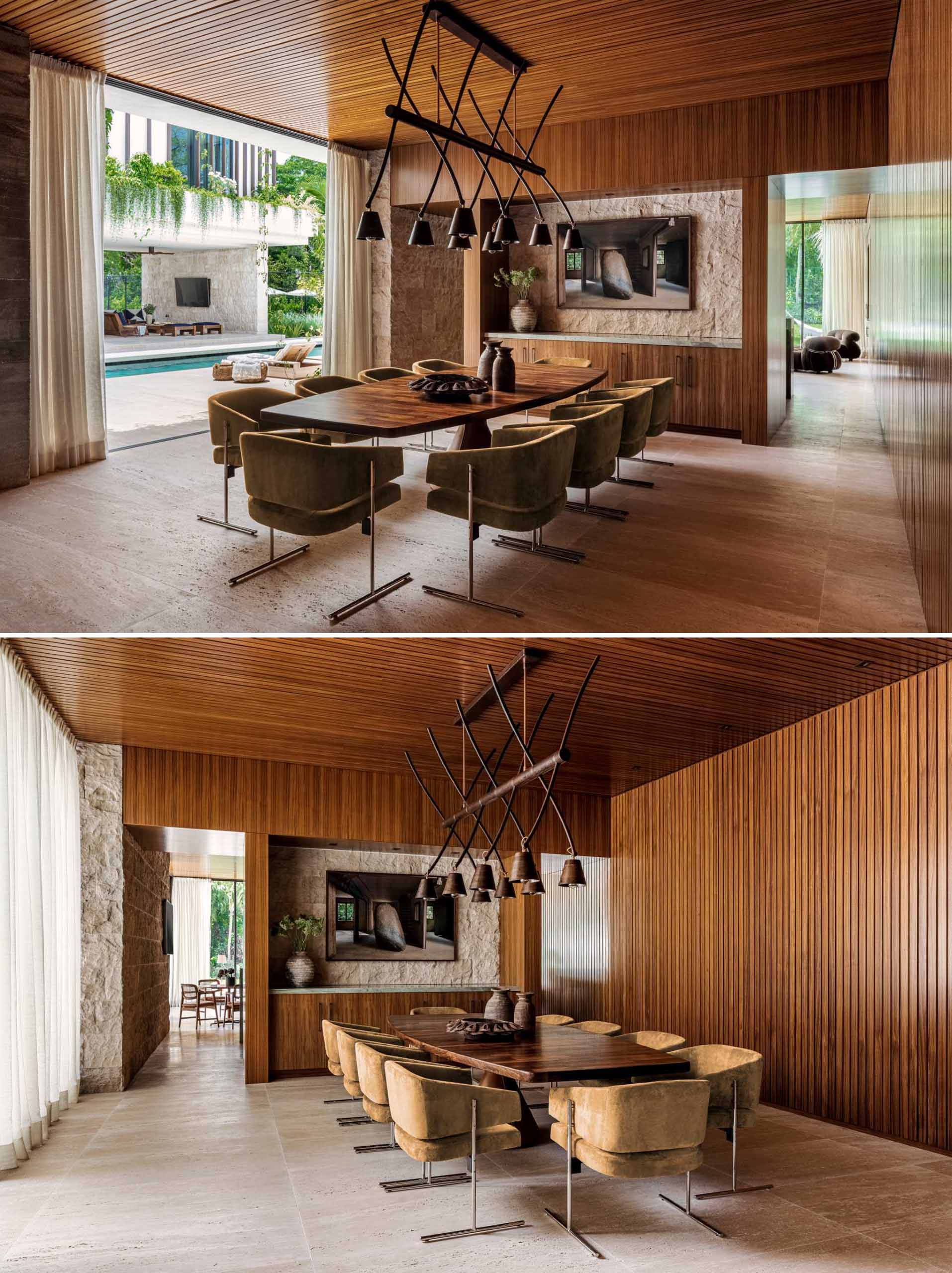 In this modern dining room, there's abundant teak paneling as well as stone accents.