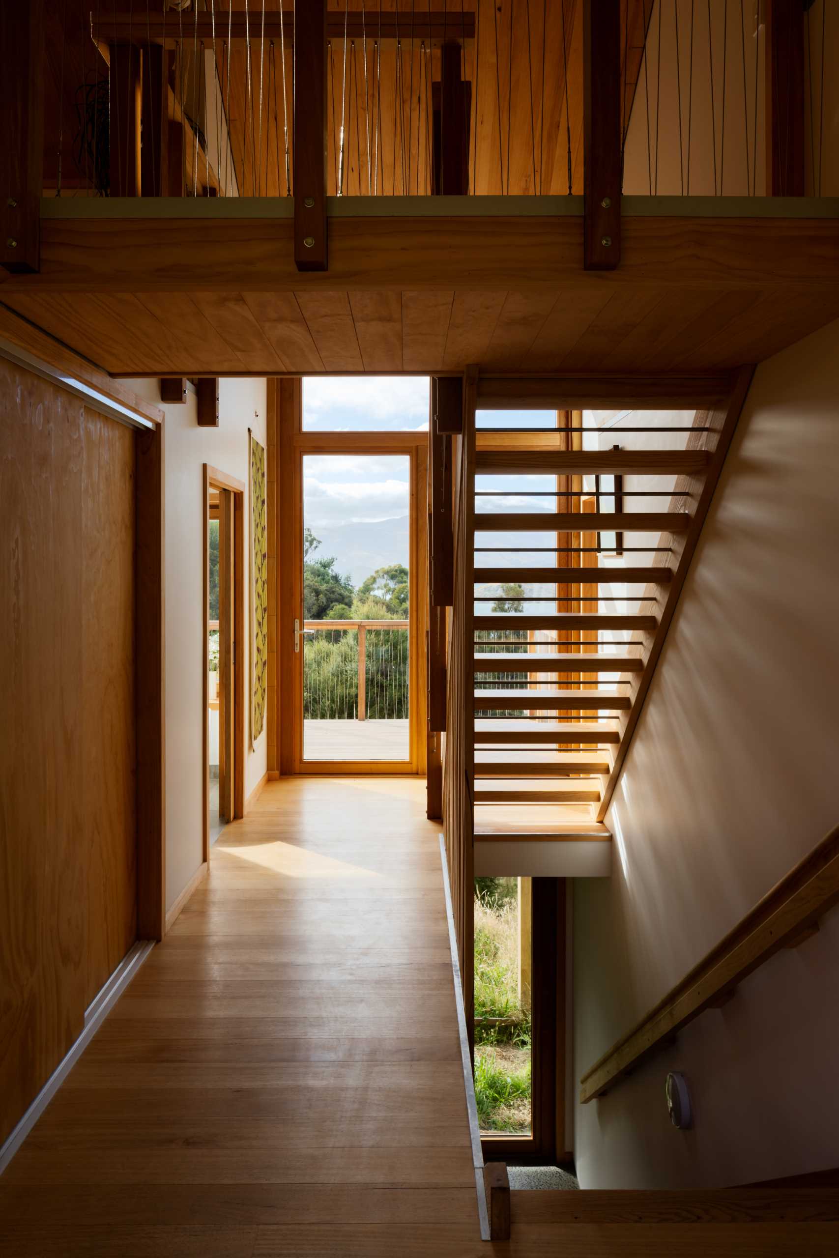 Wood stairs lead to a lofted home office, as well as the garage downstairs.
