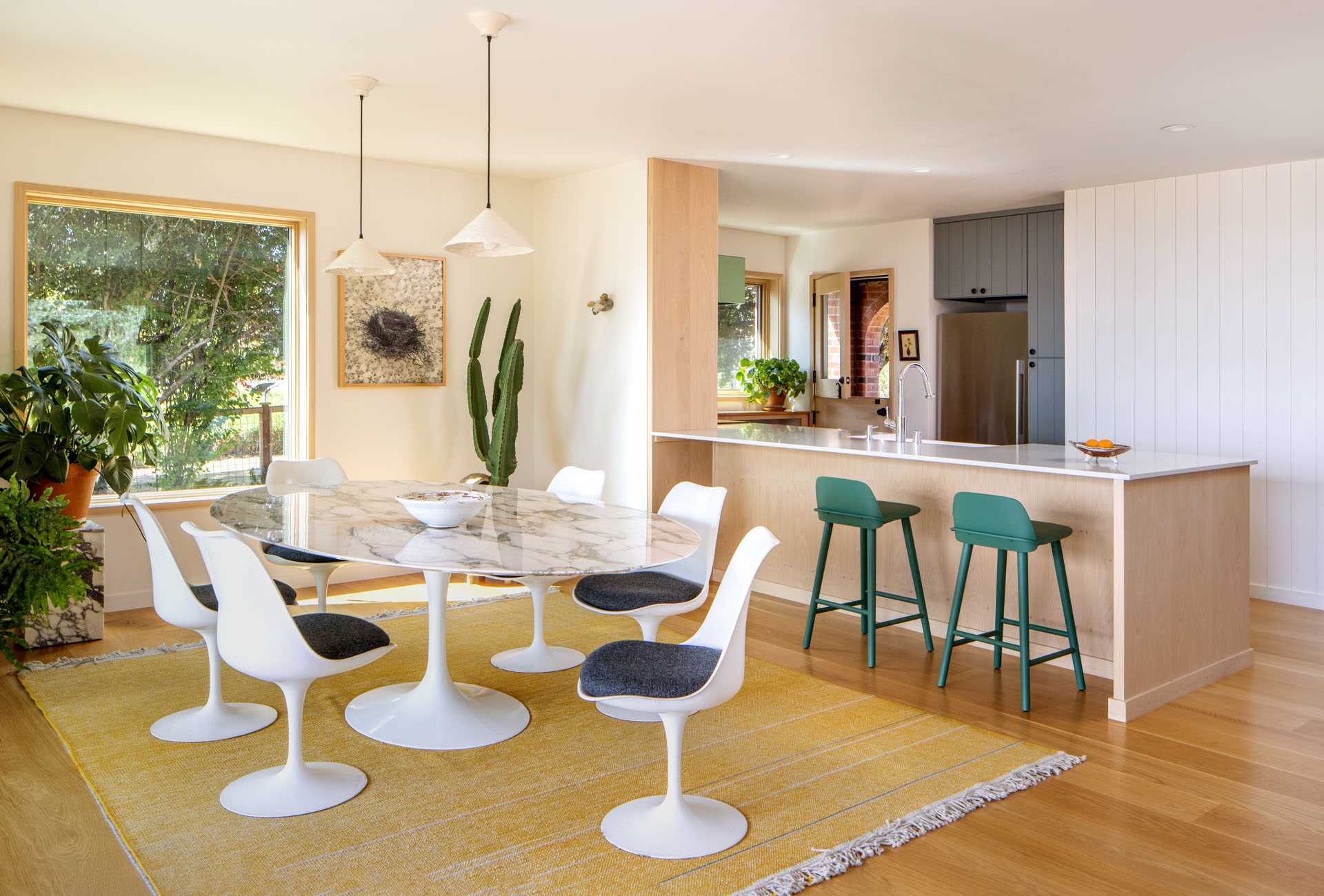 A contemporary remodeled interior with an open-plan dining area and a new kitchen.