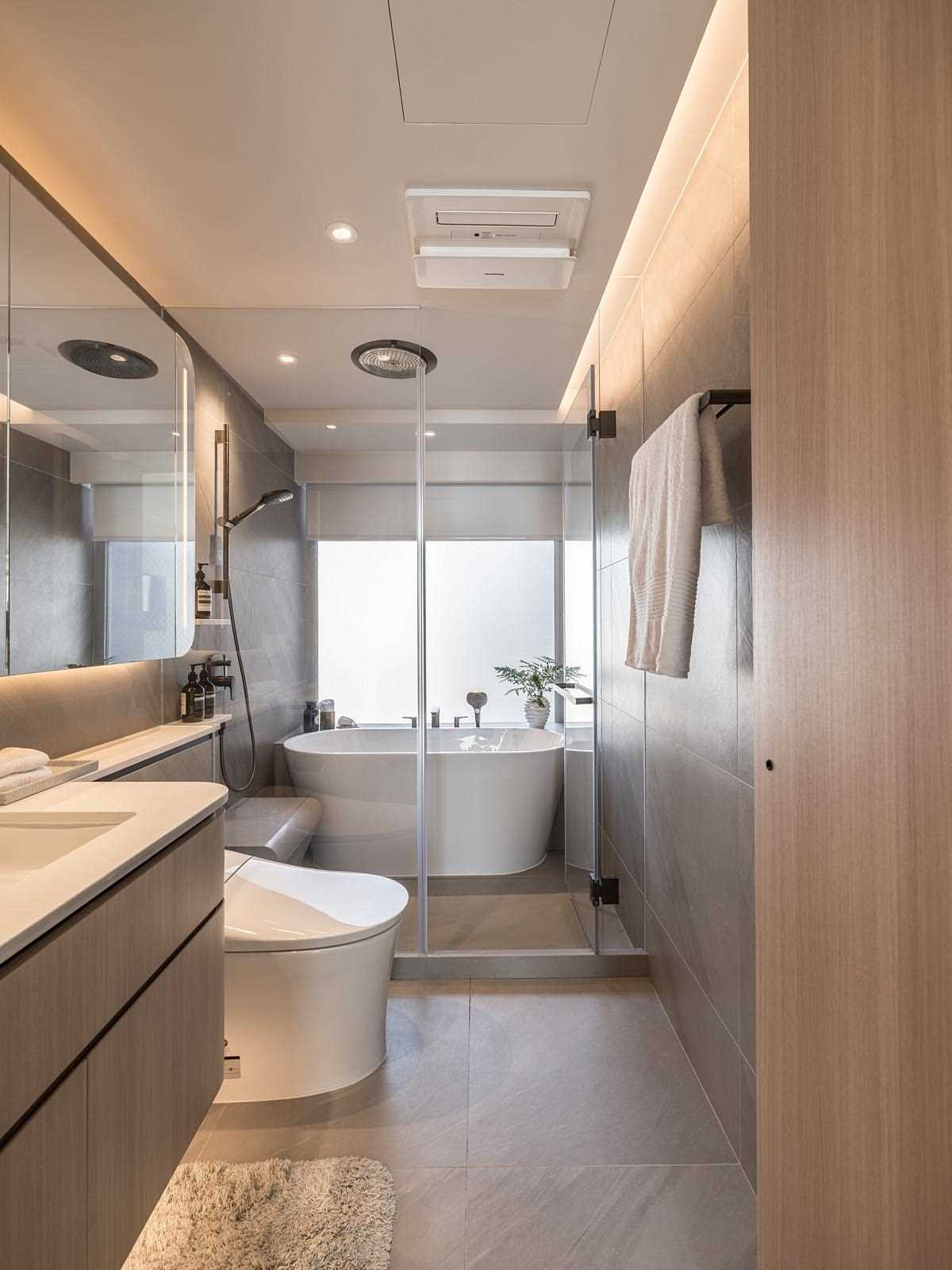 A primary bathroom with the bath and shower sharing the wet room.