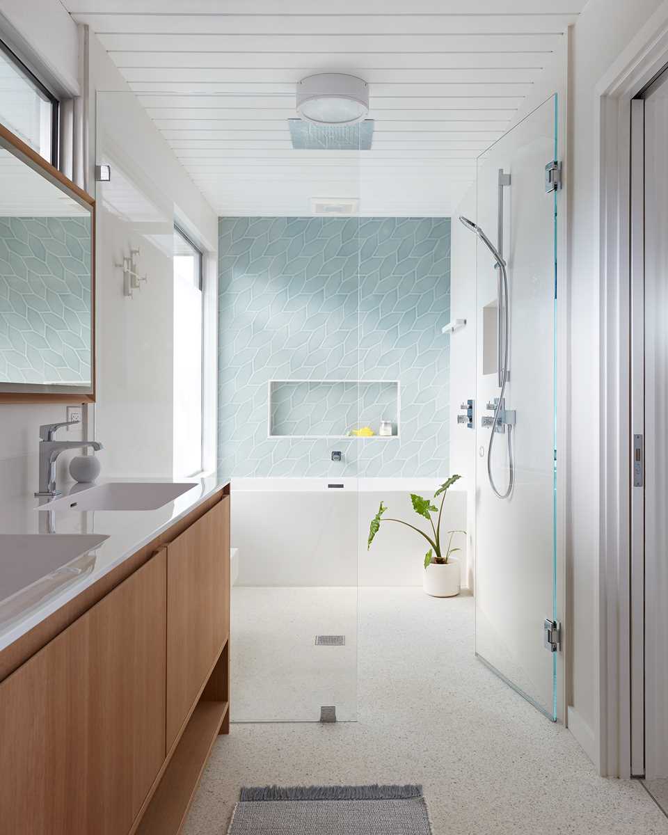In this modern bathroom, picket tile in a braid pattern has been used to create an accent wall in the shower.