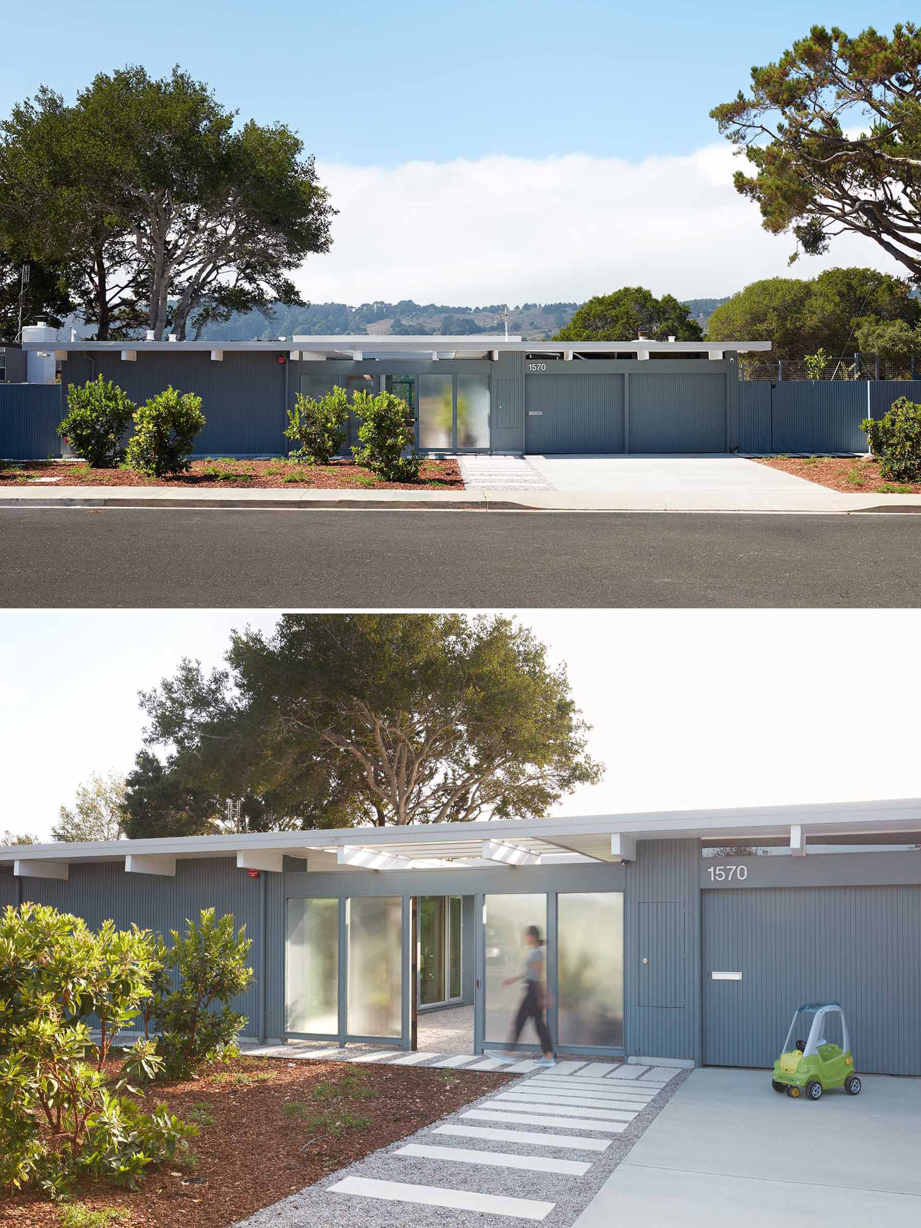 A remodeled Eichler home with a blue exteiror and white roof.