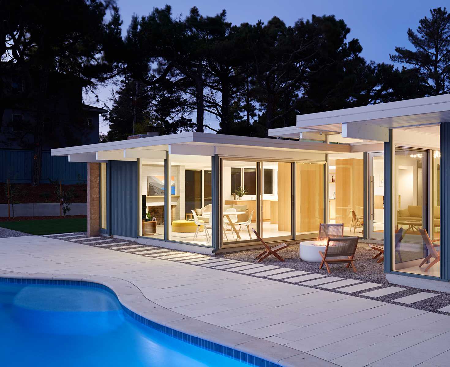 A remodeled Eichler home with a swimming pool.
