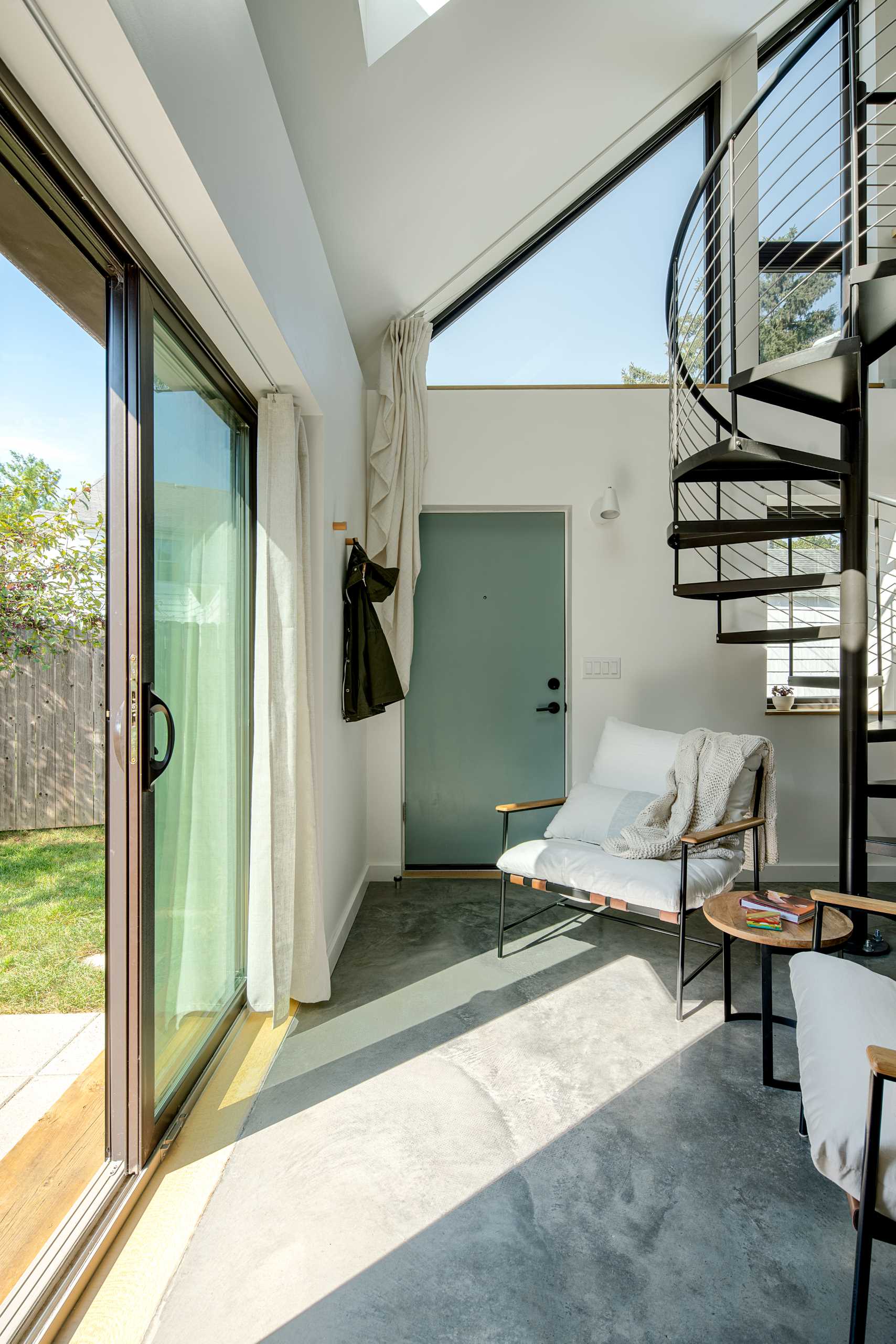 A small studio apartment with a sliding door that opens to a patio.