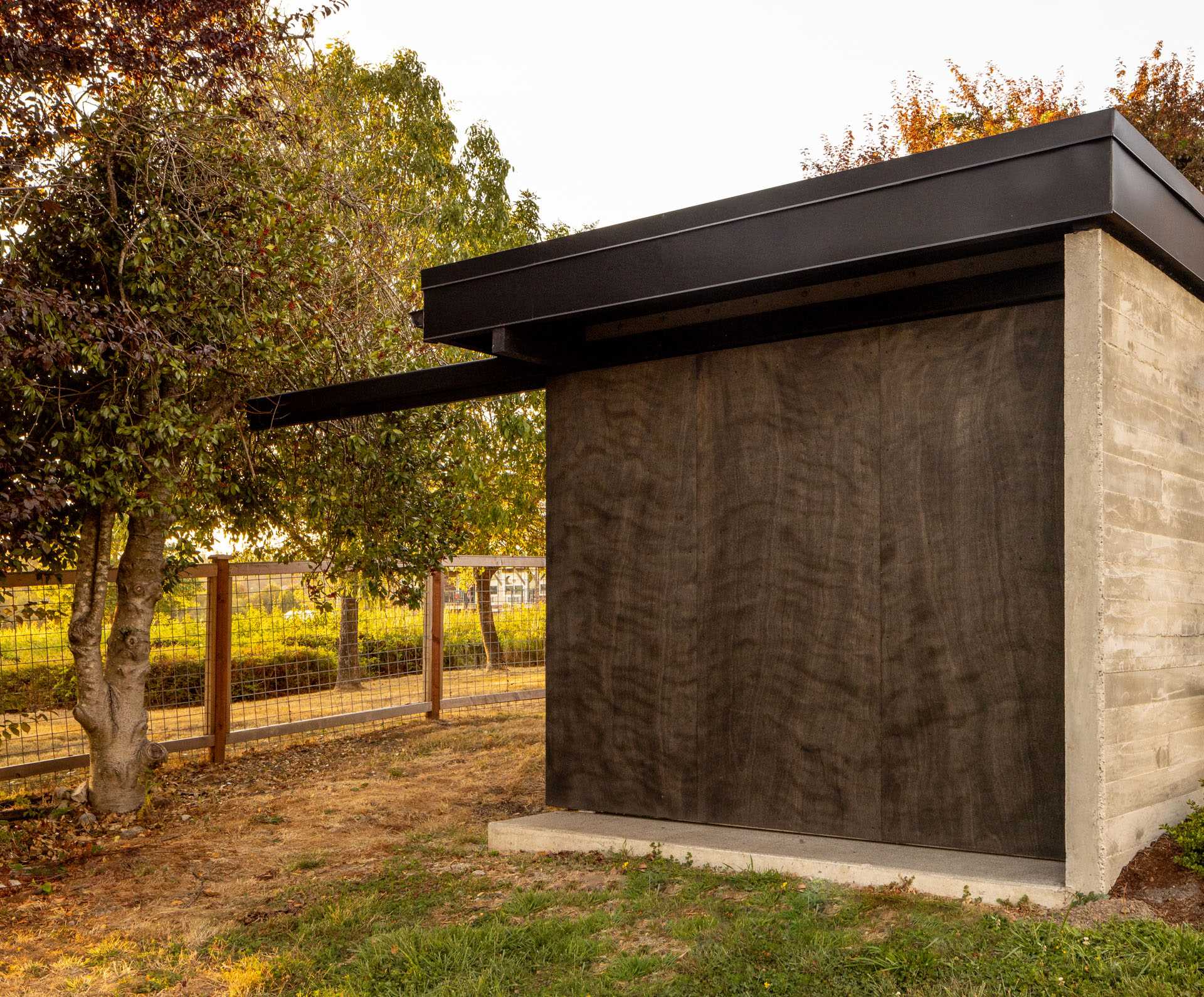 A modern boathouse with storage and a large sliding door.