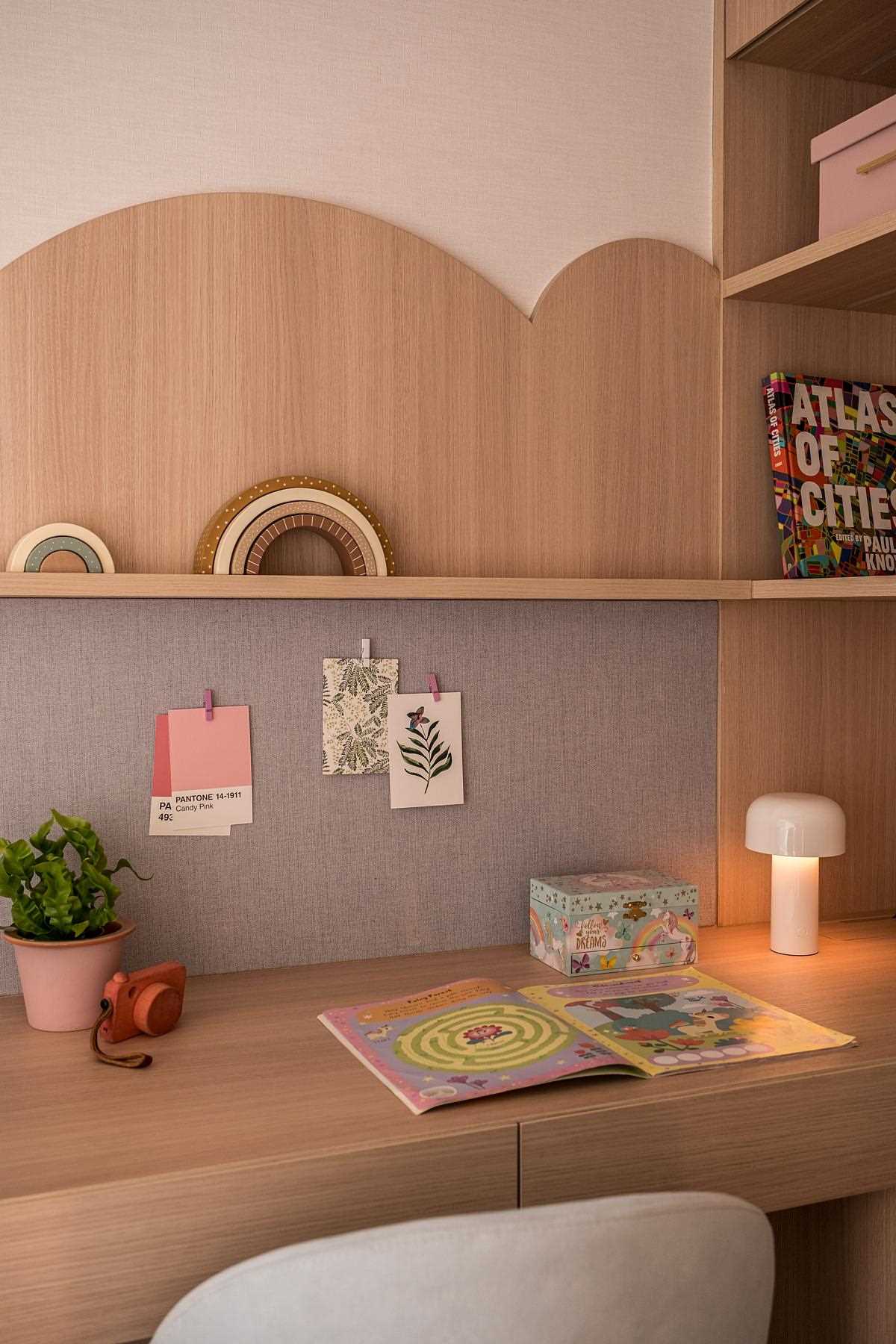 A modern and small kids room with a built-in desk.