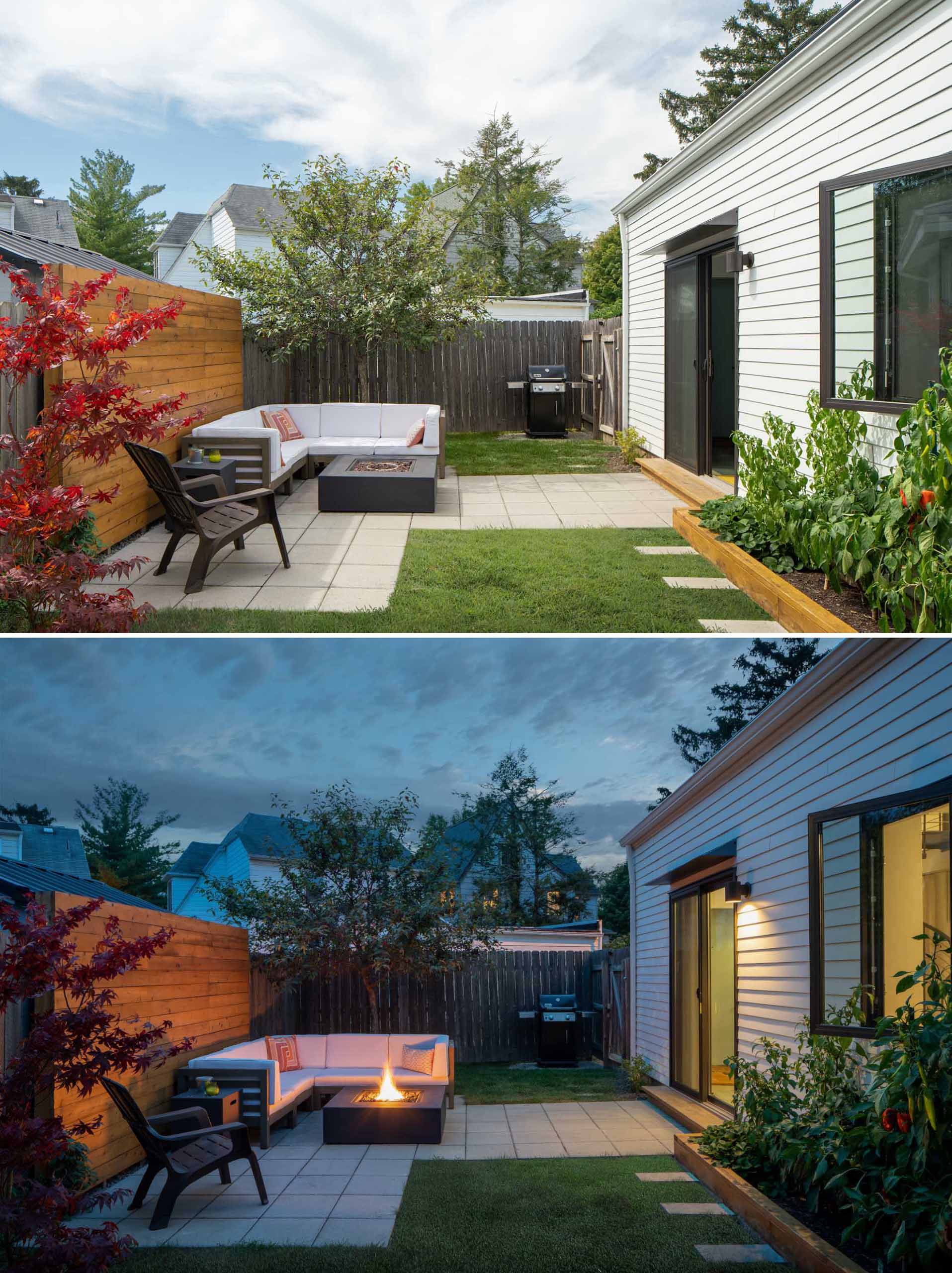 A patio where pavers and a wood accent wall have been used to create a lounge area with a fire table.