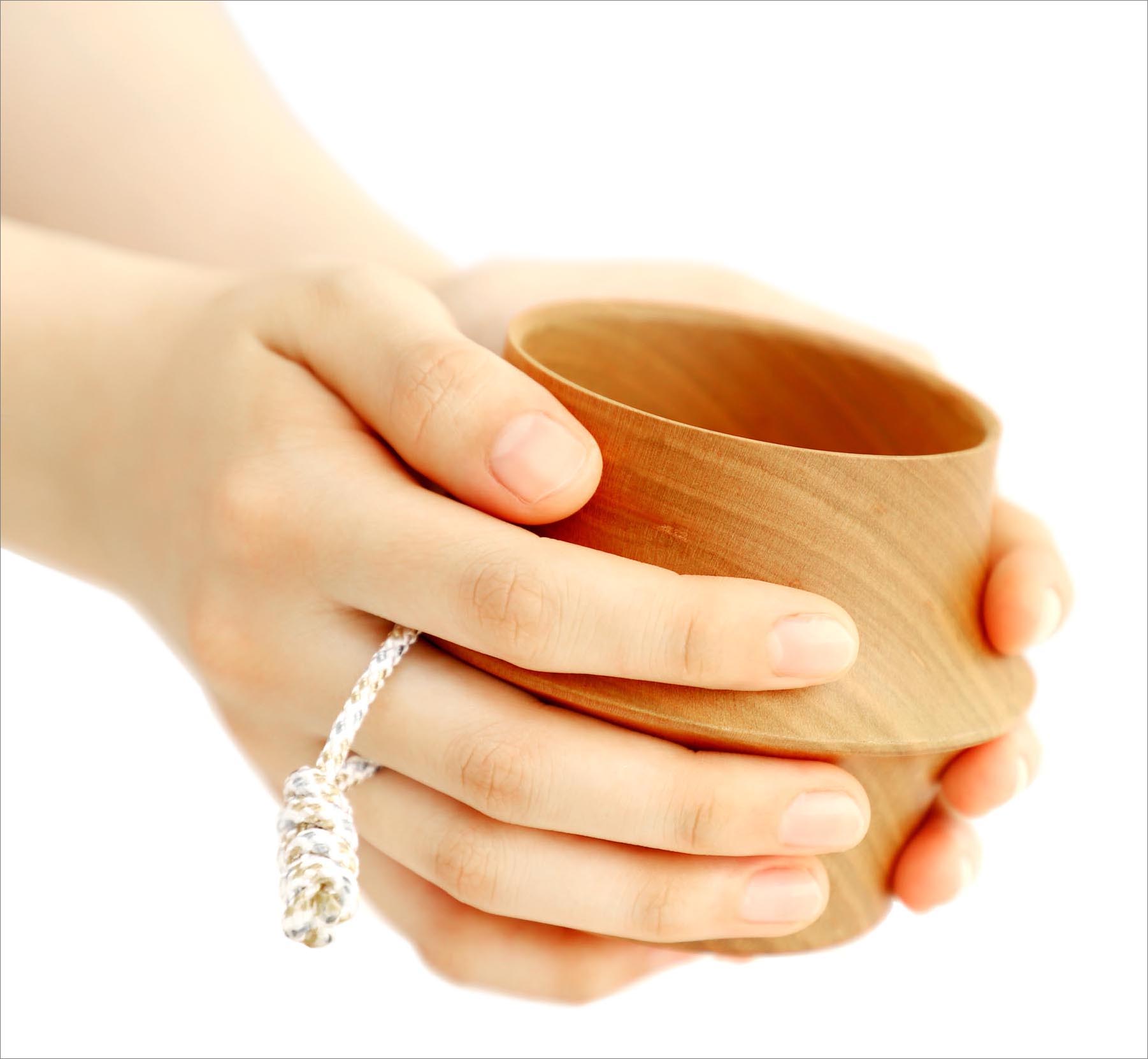 The design inspiration comes from wrapping with both hands. Its unique shape expresses the love for natural resources, and when using the cup to drink something and it being close to your mouth, the soft wooden scent flows in the air.