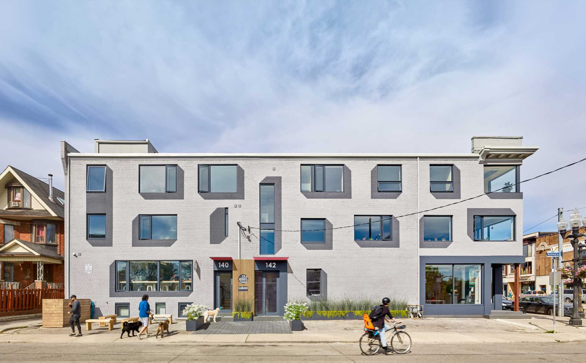 A remodeled brick building with painted drop shadows surrounding the windows.