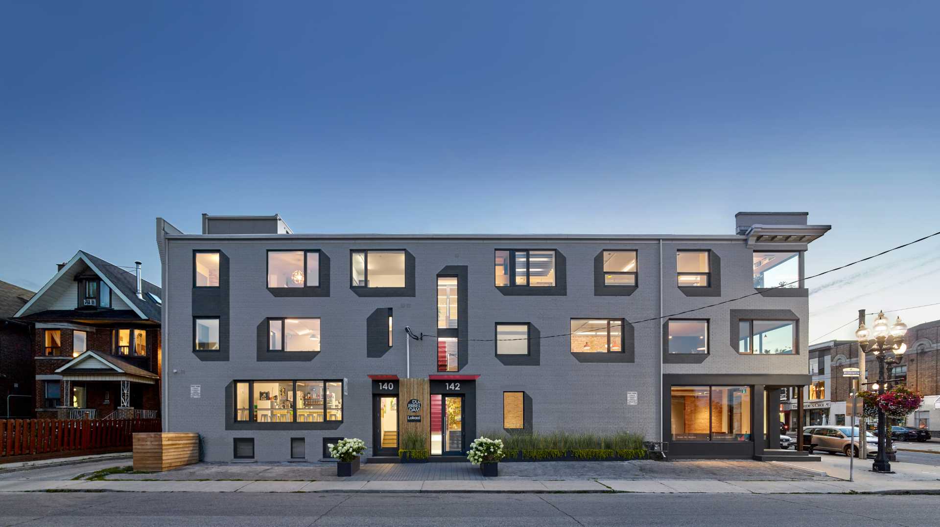 A remodeled brick building with painted drop shadows surrounding the windows.