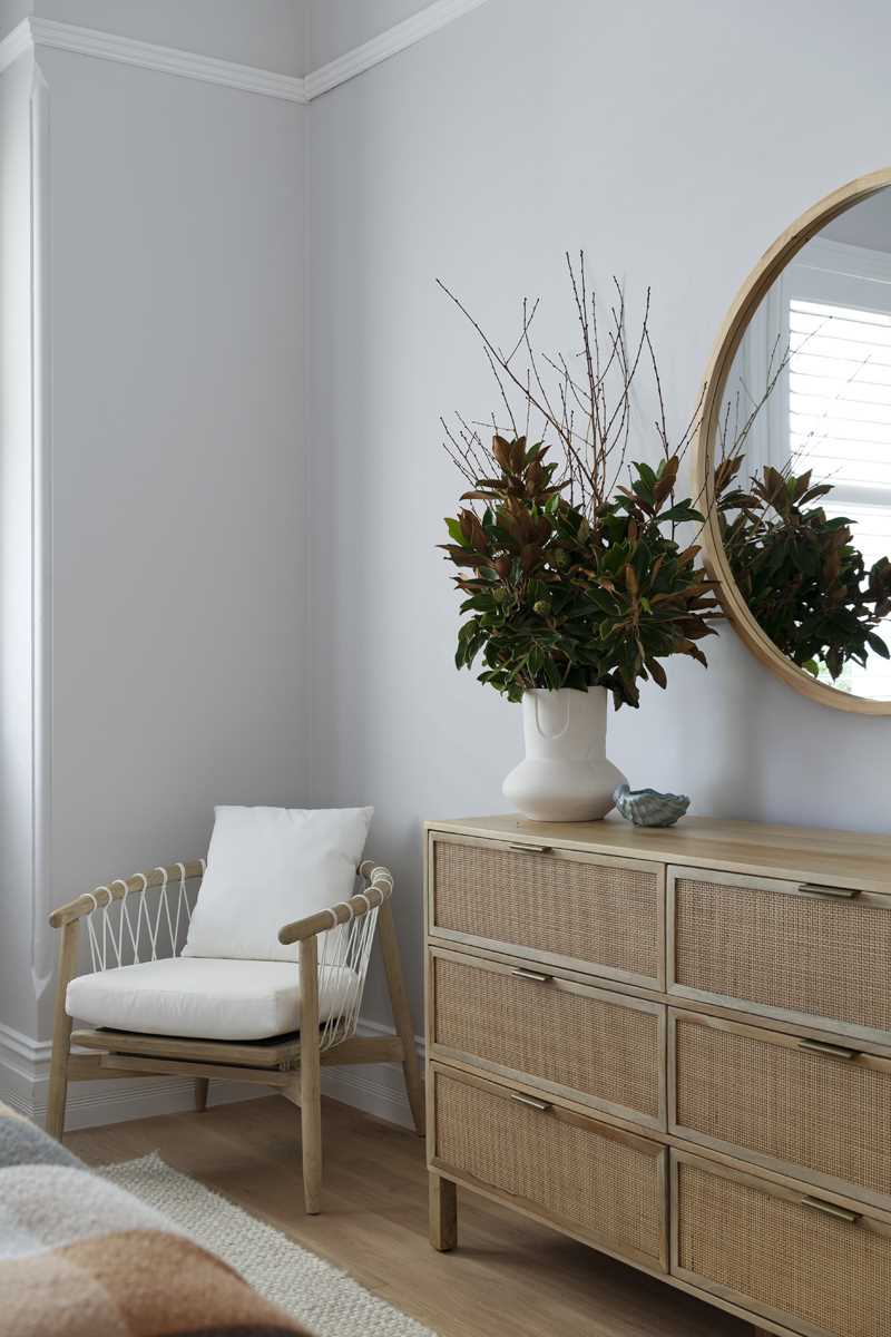 A contemporary bedroom with a colour palette of rusty orange, blues, and browns, and wood accents.