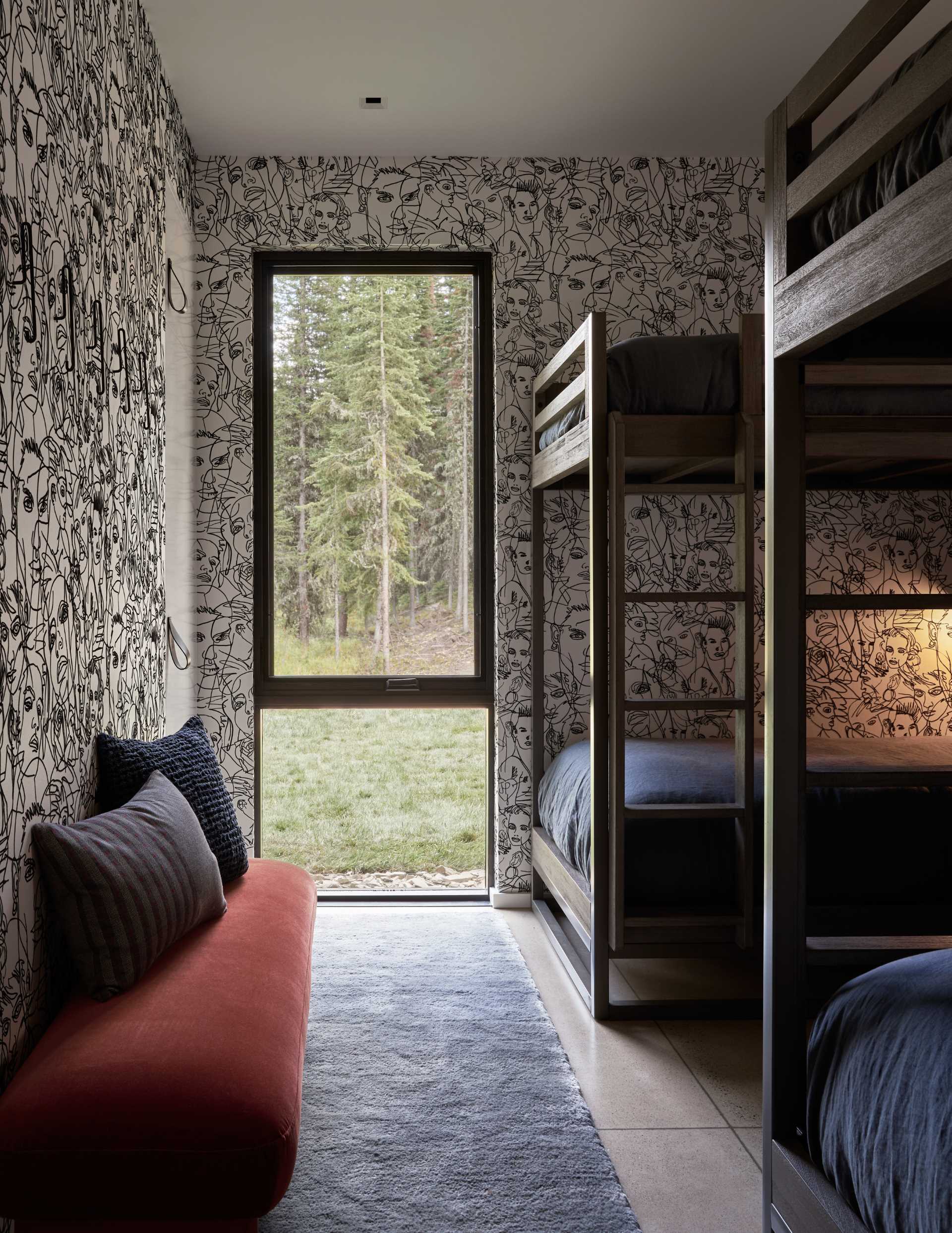 A modern bedroom with artistic wallpaper and multiple bunk beds.