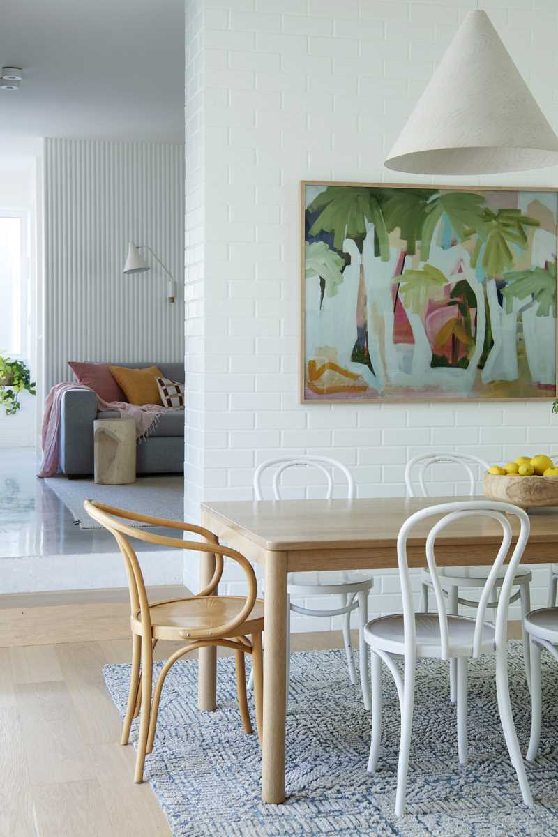 A modern dining area with white colour palette and wood accents.