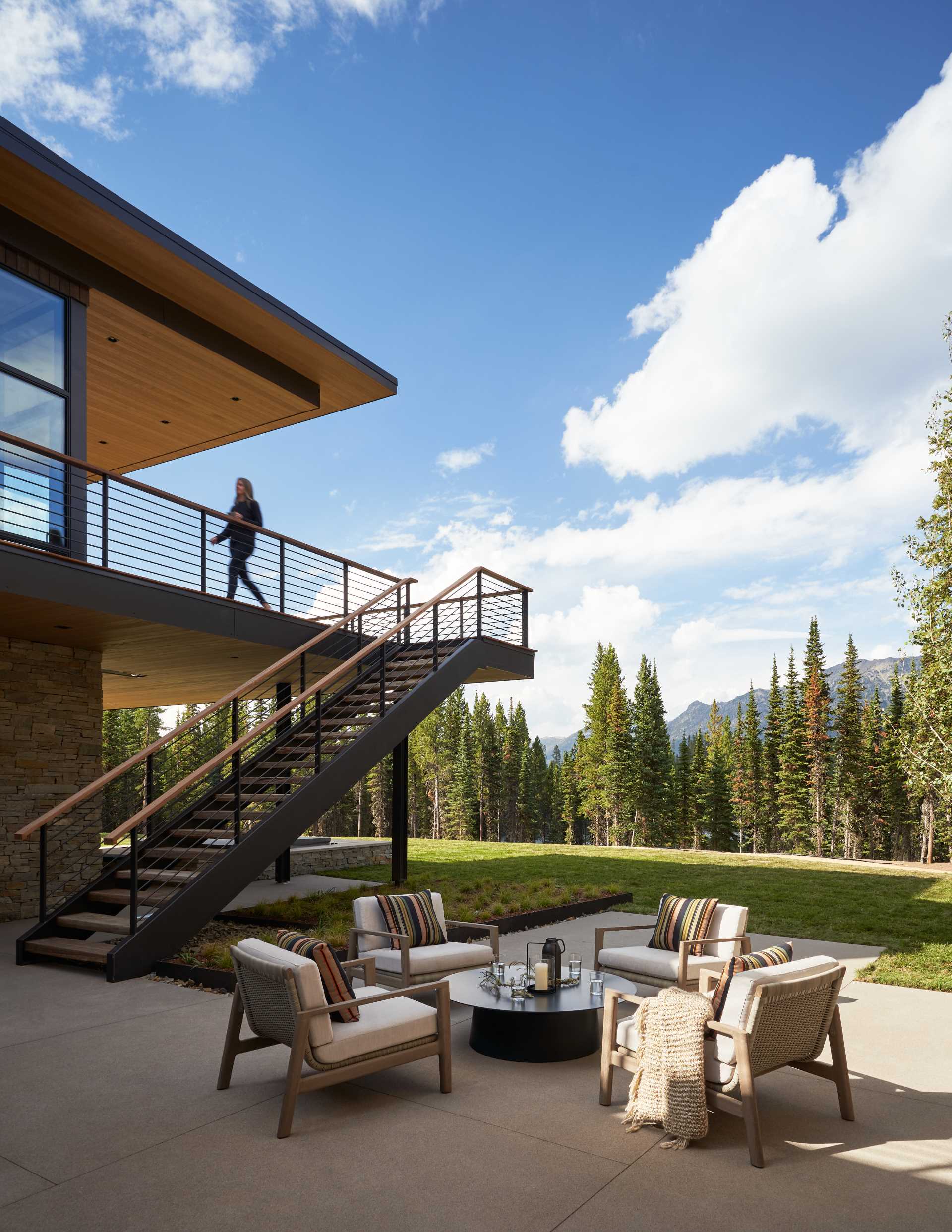 A modern mountain home with an outdoor patio.