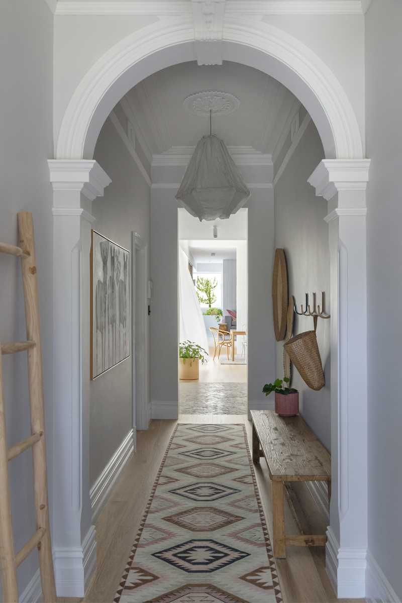 A long hallway connects the original home and the new rear addition. It also acts as the entryway.