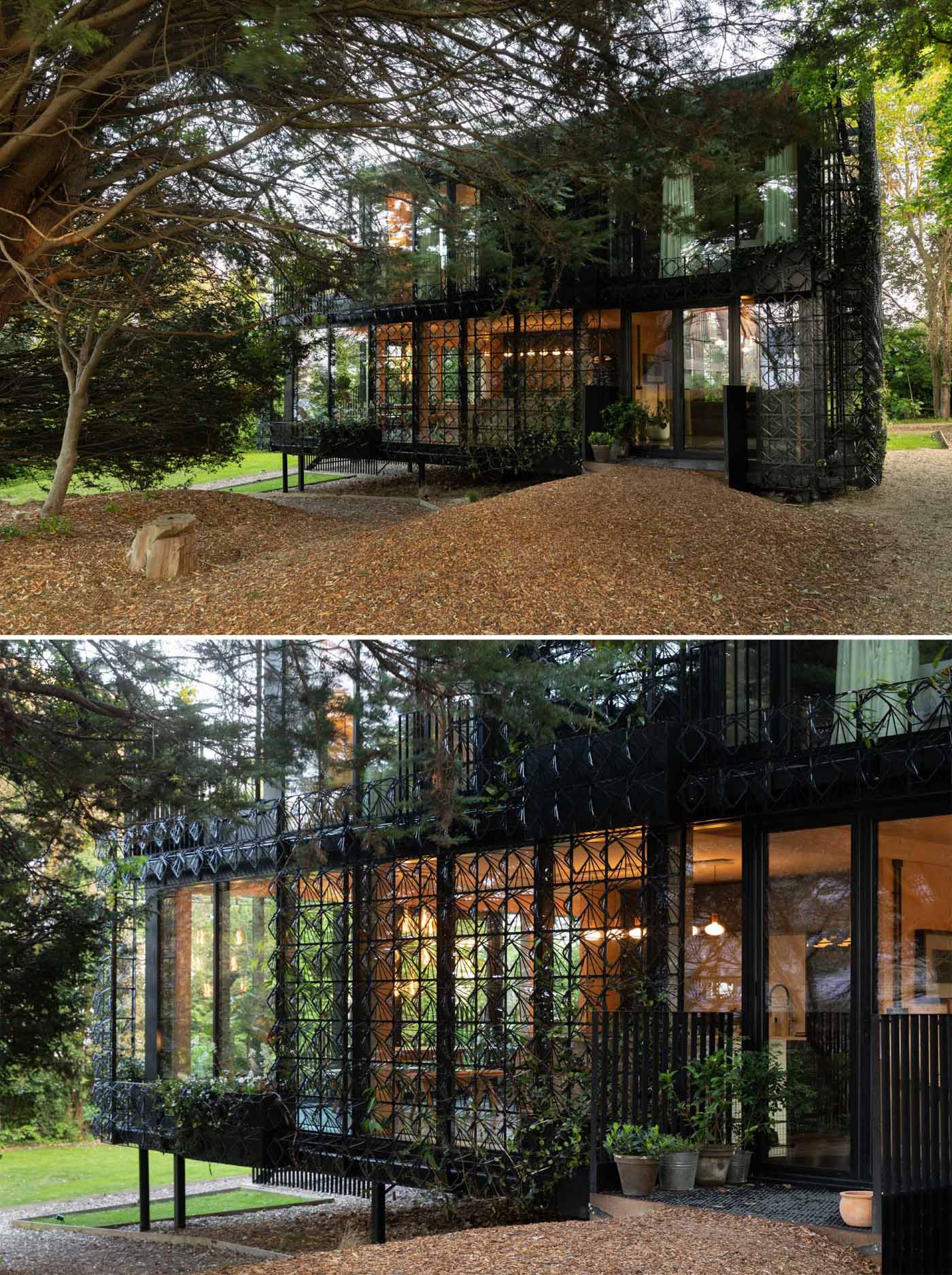 A modern black house with a sculptural facade designed to let plants grow on the exterior over time.