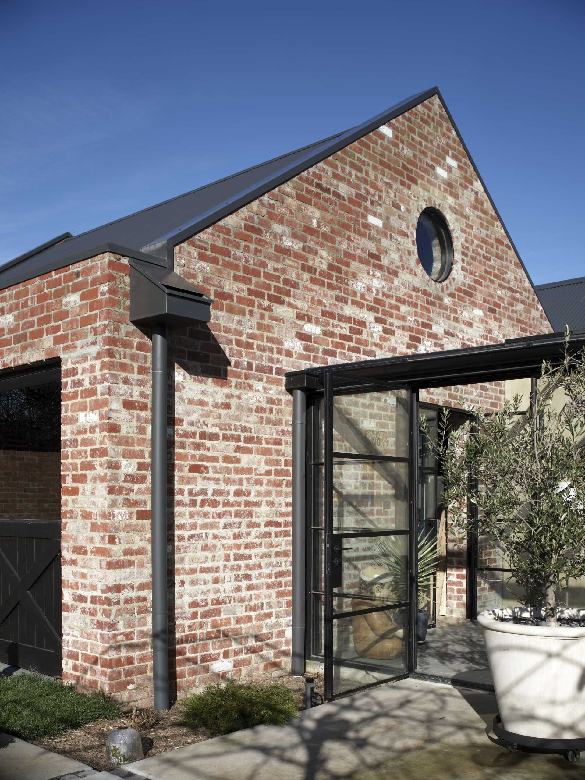 This garage is constructed from recycled brick, with a Versiclad roof over exposed timber trusses.