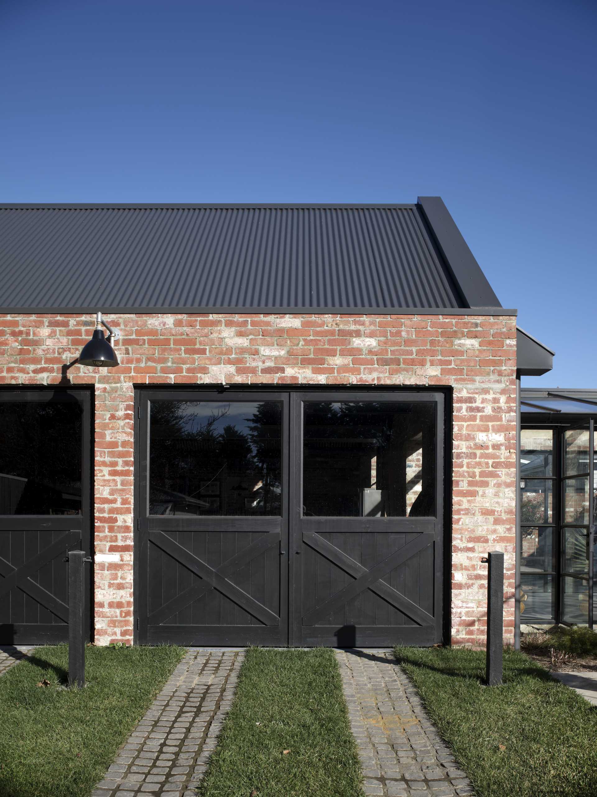 This garage is constructed from recycled brick, with a Versiclad roof over exposed timber trusses.