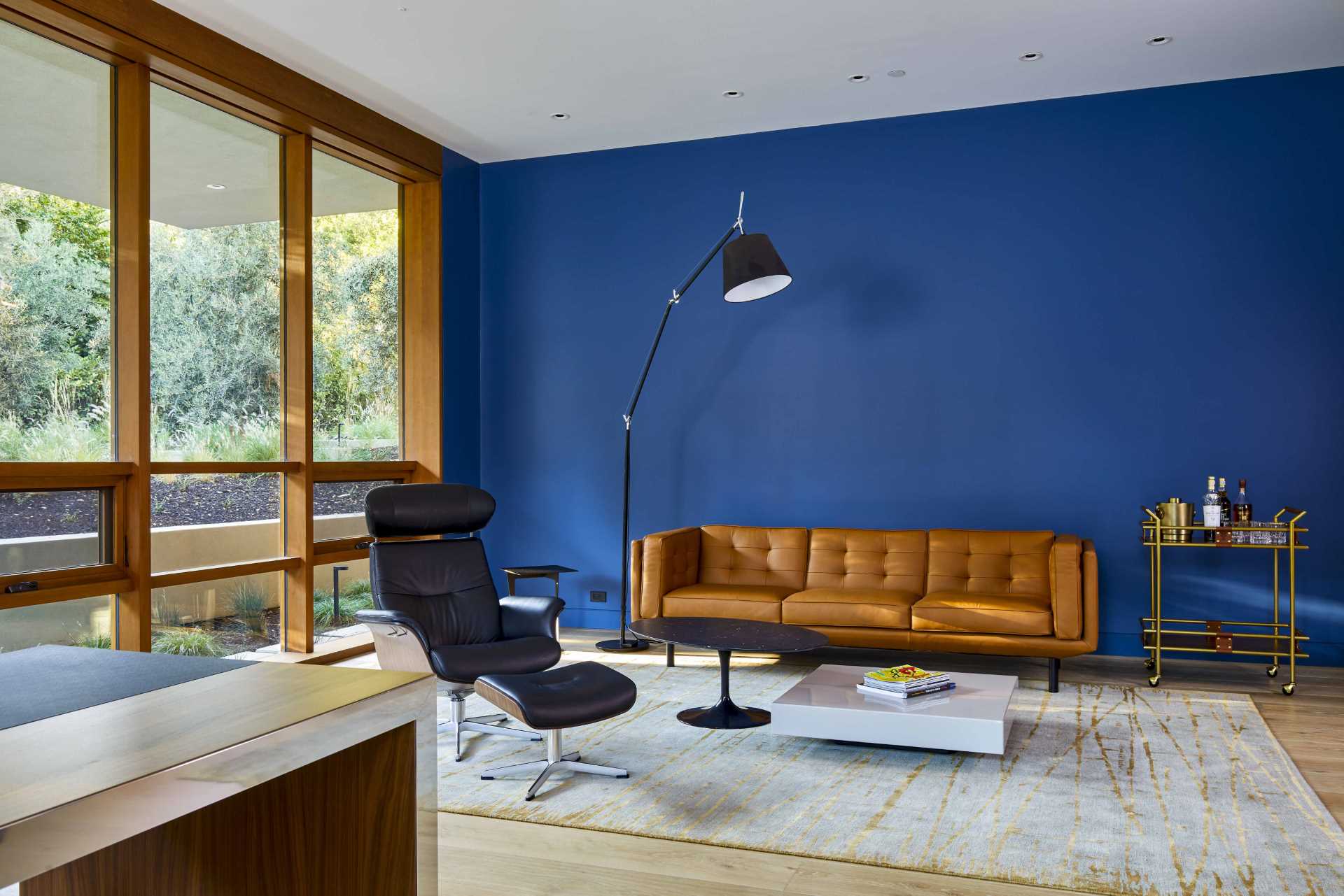 A modern home office with a blue accent wall.