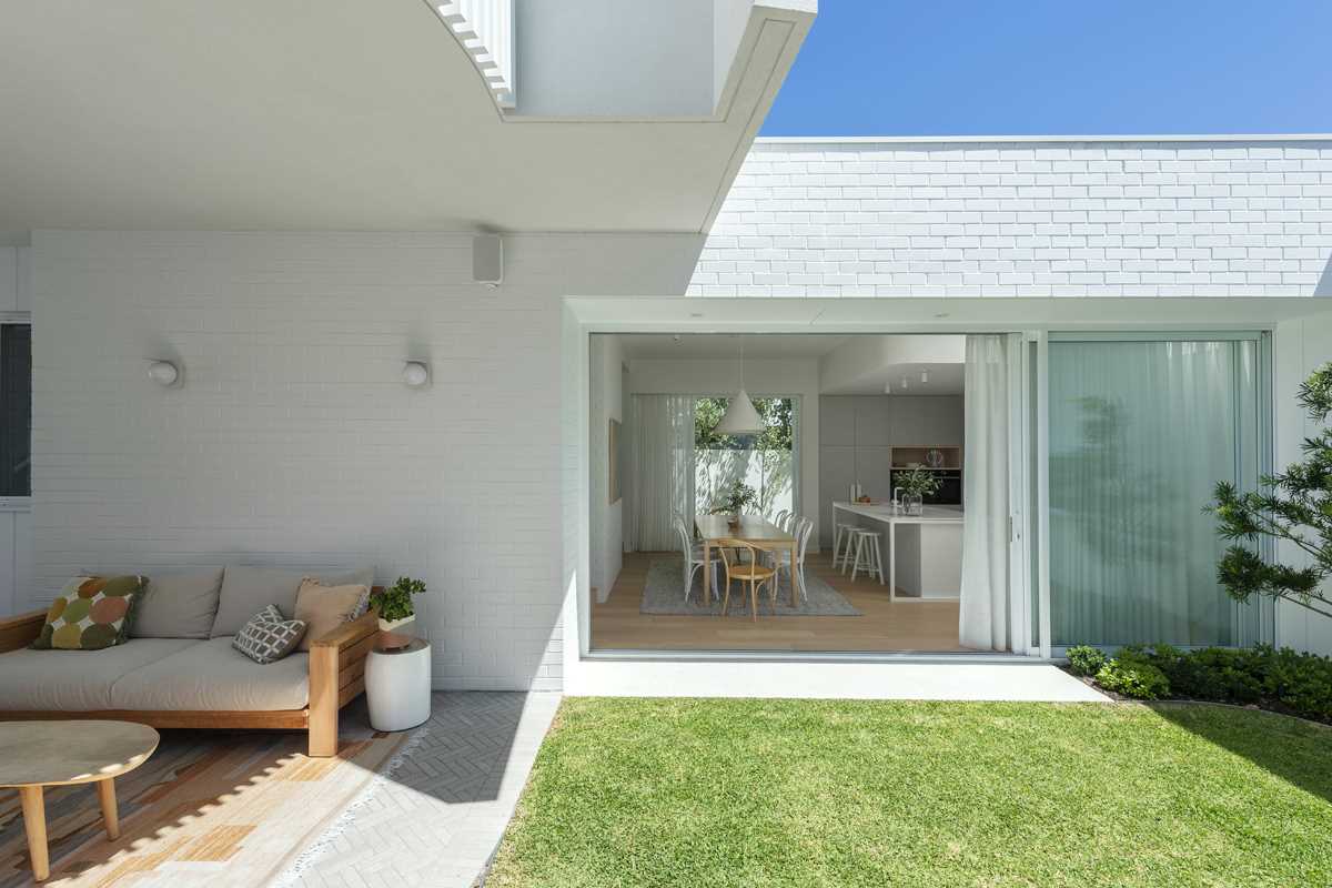 Sliding glass doors connect the exterior and interior spaces of this home.